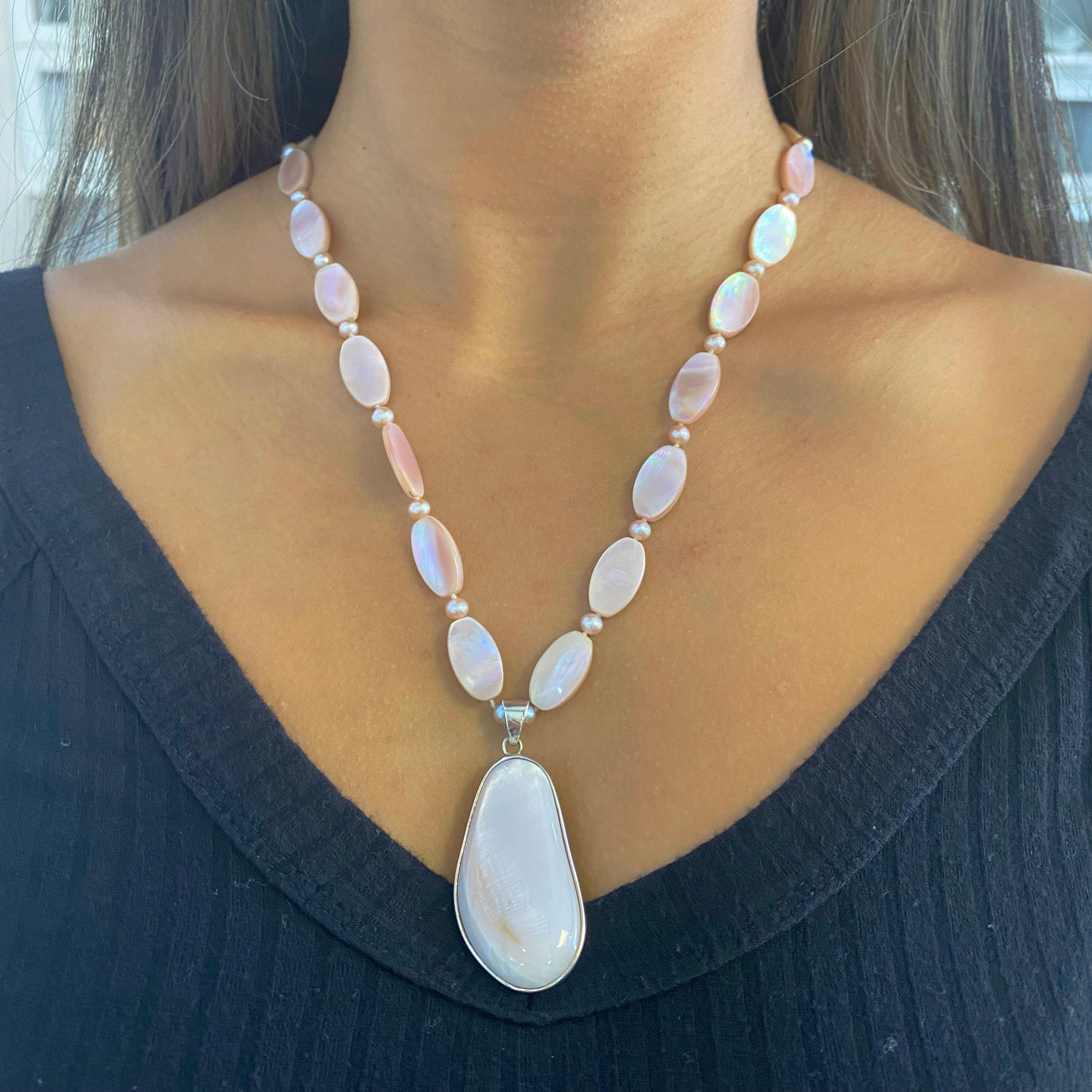 This is a Pink Mother-of-Pearl pendant necklace that is absolutely stunning. Mother of Pearl is a strong, resilient stone and it gives off an iridescent color. It is so easy to appreciate the shine and beautiful pink color of this necklace. The