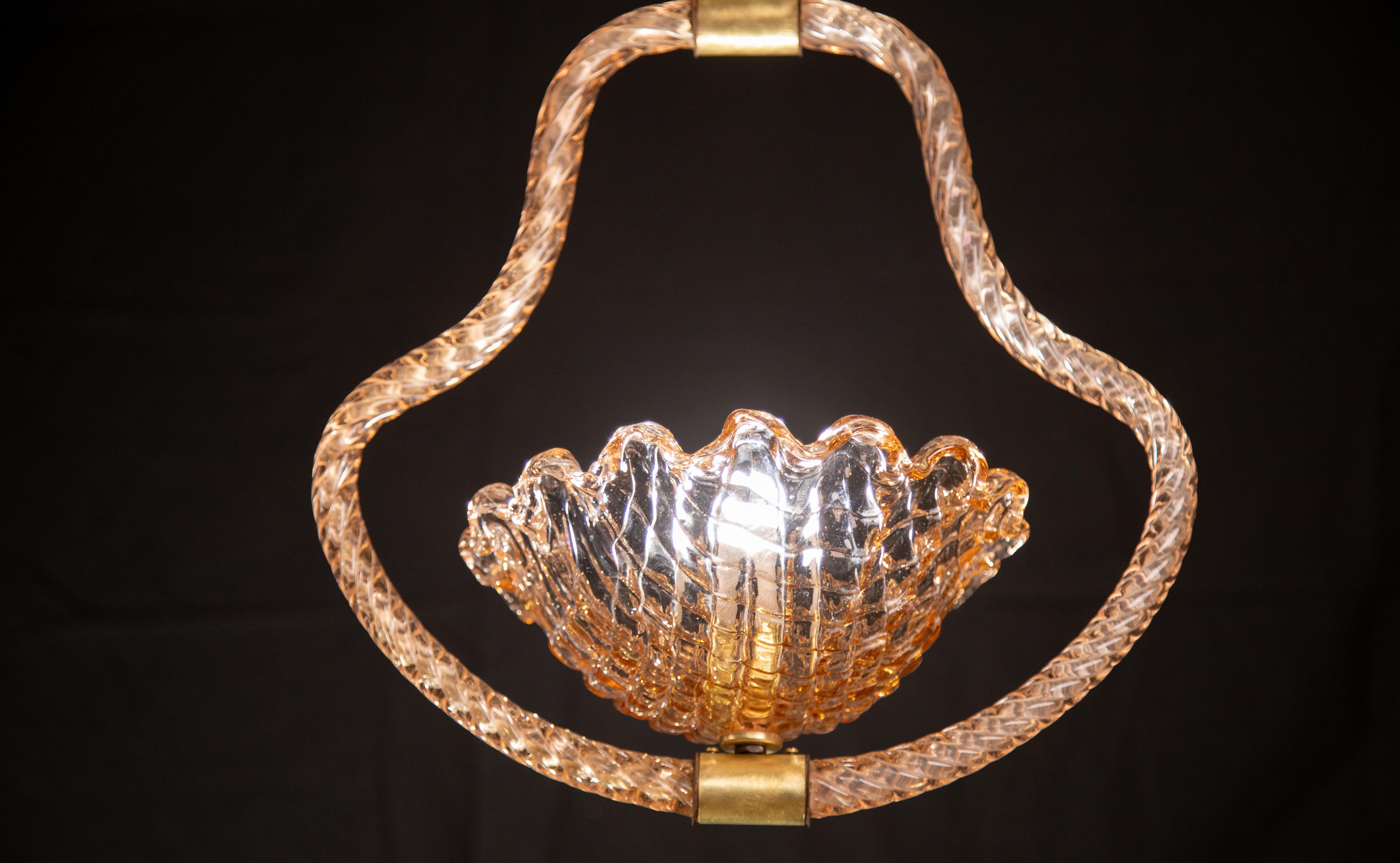 Stunning Murano chandelier by artist Ercole Barovier with rare pink glass.
The pendant consists of 4 glass elements and a brass structure.
It mounts a European standard e27 lamp.
It measures 80 centimetres in height and 40 centimetres in