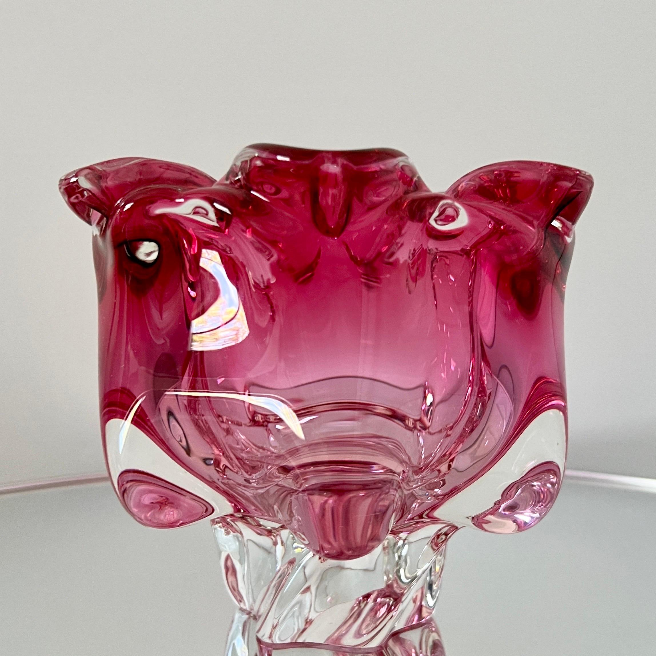 Mid-Century Modern large footed bowl or vase in pink fuchsia Murano glass. hand blown using Sommerso technique whereby the pink glass is submerged within the clear glass. Features a stylized floral design with curved sides and a slanted base in