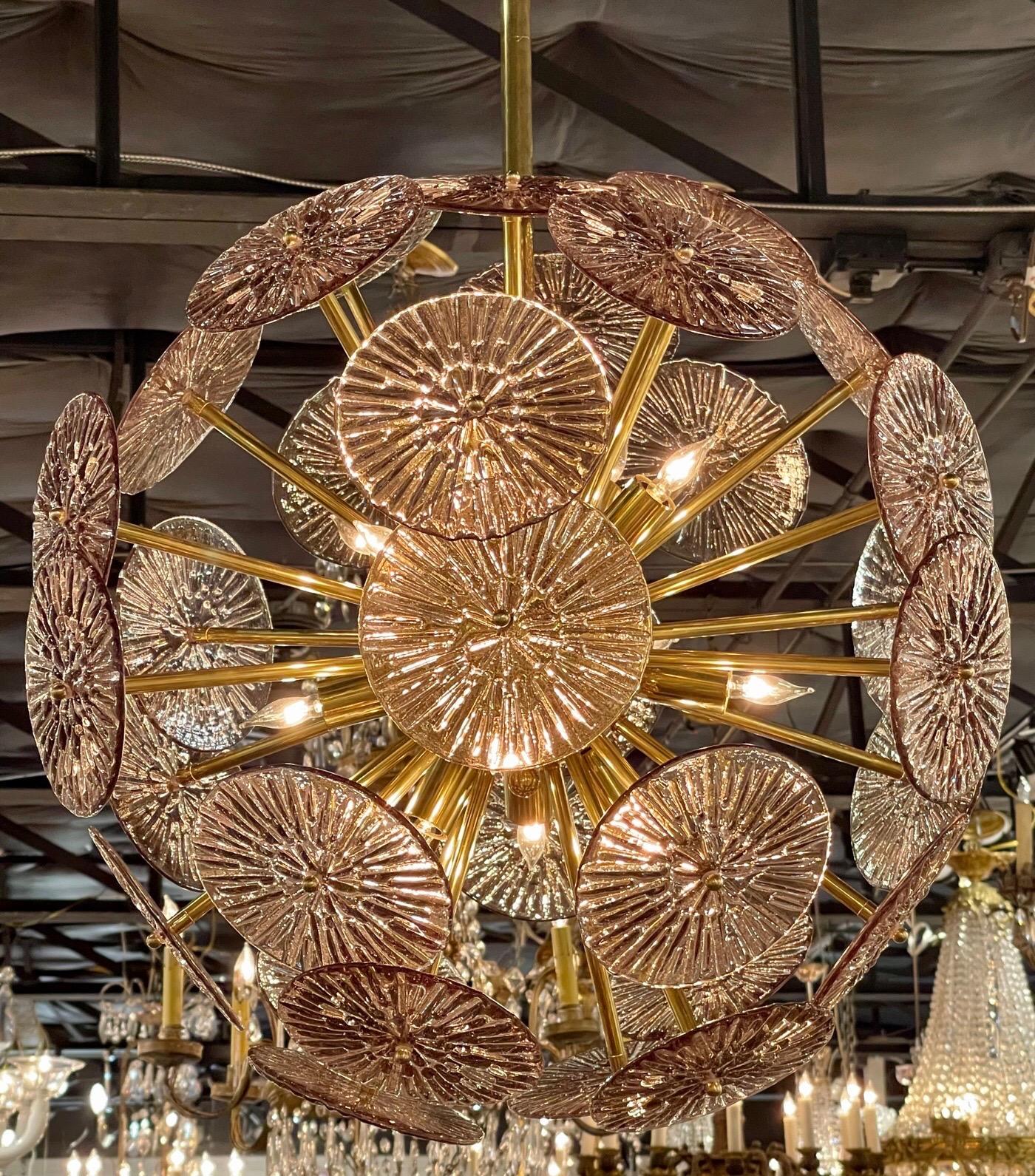 Decorative modern pink murano glass and brass like disc form sputnik sphere chandelier. The discs have a flower like appearance and the brass base is super pretty as well. A true work of art!