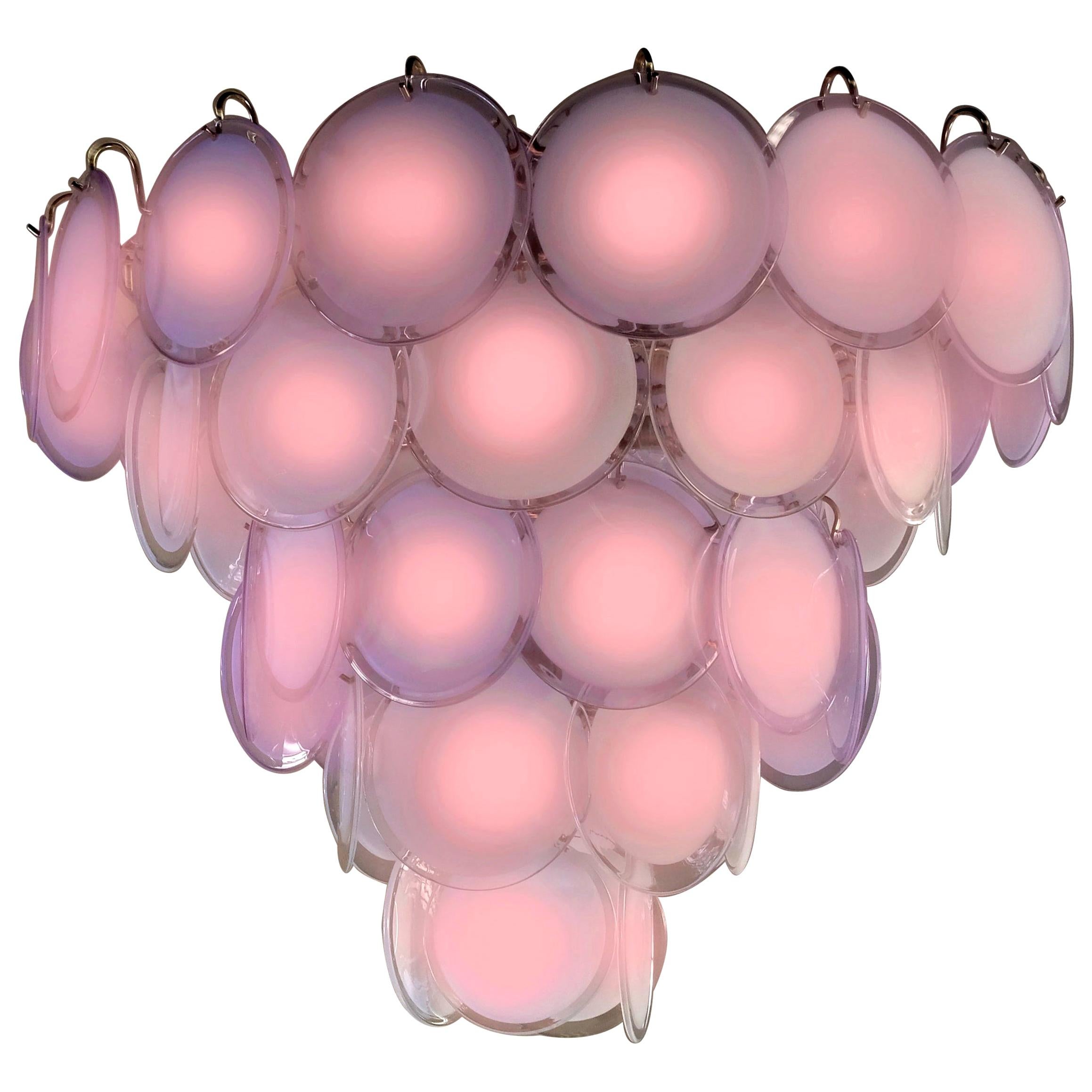 Spectacular chandelier by Vistosi made with 50 pink Murano discs.
16 E 14 light bulbs. We can wire for your country standards.
Available also a pair of small 24 disc chandelier and four pairs of sconces.