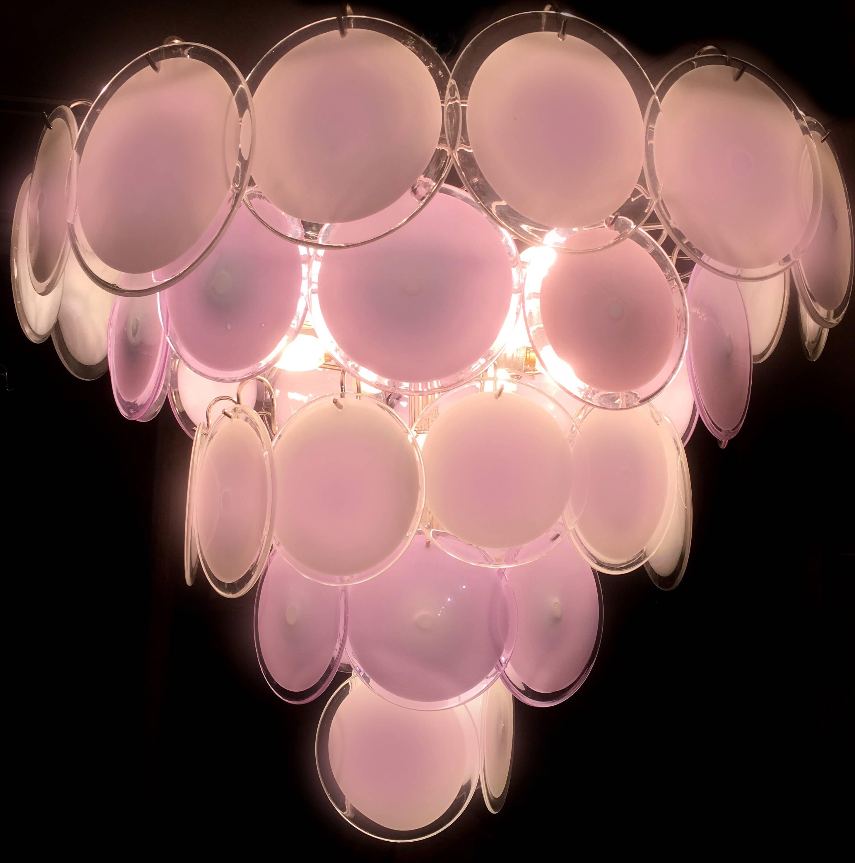 Spectacular chandelier by Vistosi made with 50 pink Murano discs.
16 E 14 light bulbs. We can wire for your country standards.
Available also a pair of small 24 disc chandelier and four pairs of sconces.