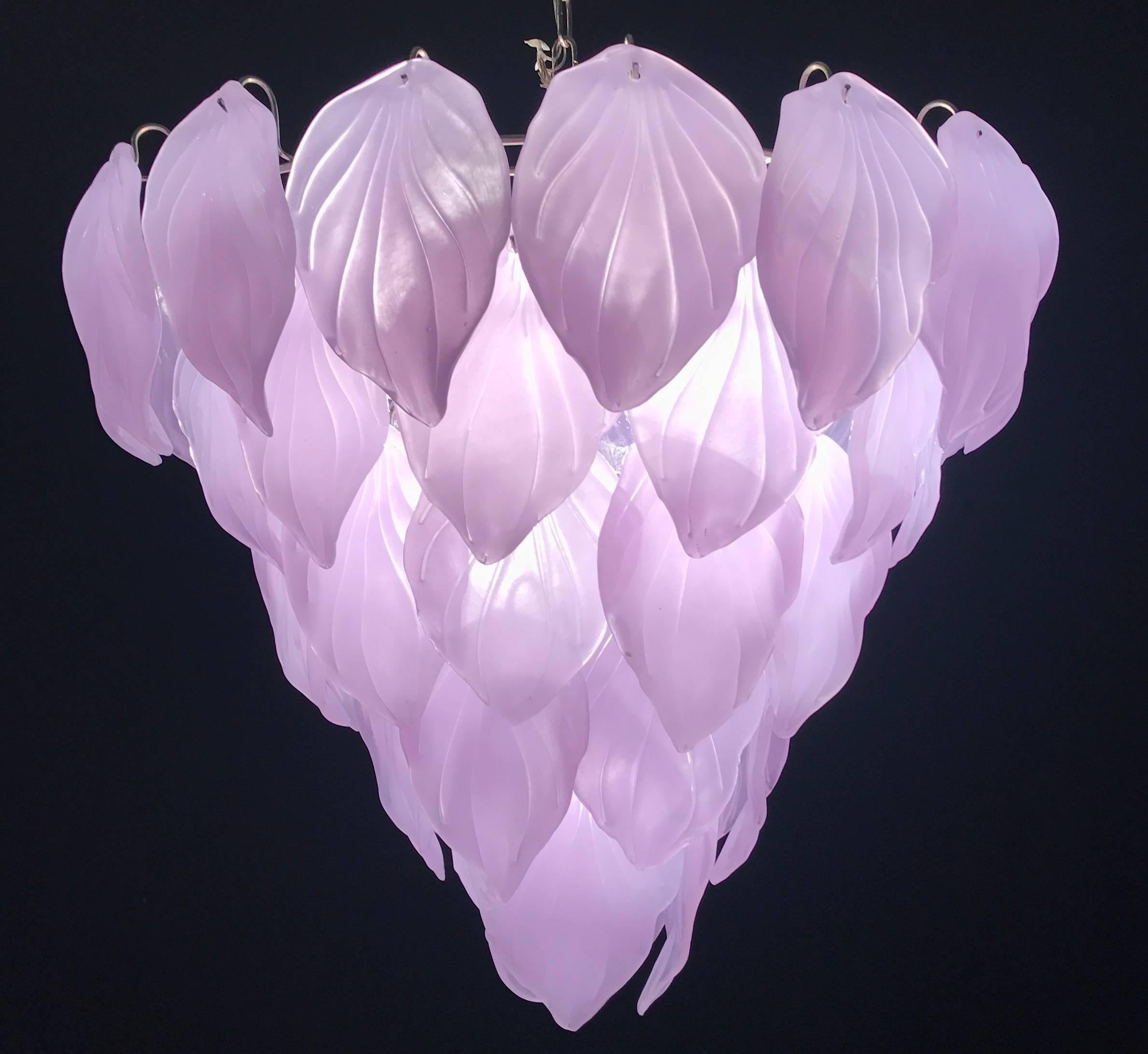 Magic transformation of the glasses color from violet to pink when the light is on. With 50 precious hand blown Murano glass leaves on five levels. Available also a pair and a 2 pairs of sconces.
Measures: Height without chain 65 cm (26 inches).