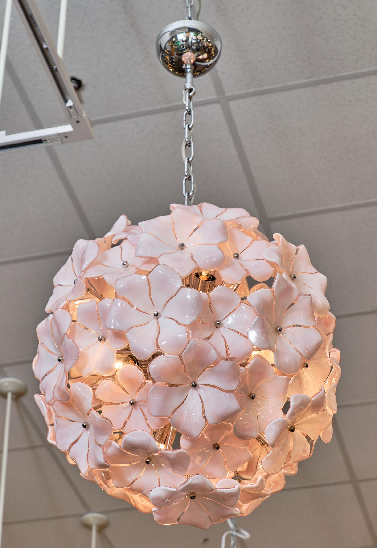 Murano Glass pink flower chandelier by Cenedese. This stunning piece has such a light, delicate pink color and brings such a warmth to any space. It has been newly wired to fit US standards. The current height from the ceiling is 37