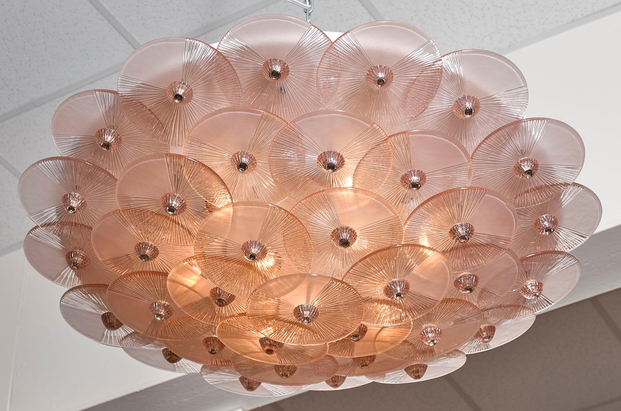 Pink Murano glass flush mount in the style of Carlo Nason. This spectacular fixture features hand-blown discs of textured pink glass with glass finials. It has been newly wired to fit the US standards.