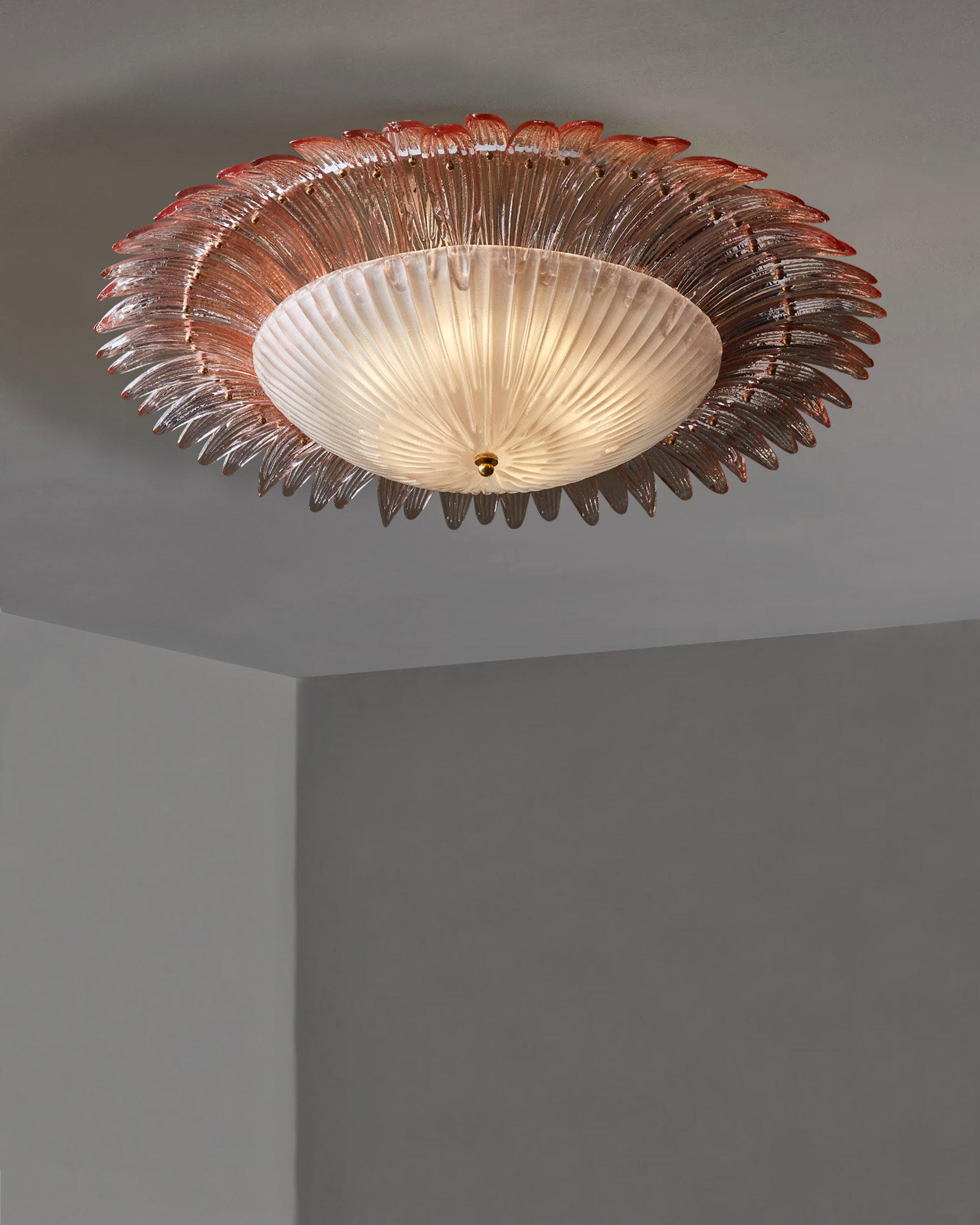 Large flush mount fixture made of a pink Murano glass center plate and small leaves all around.