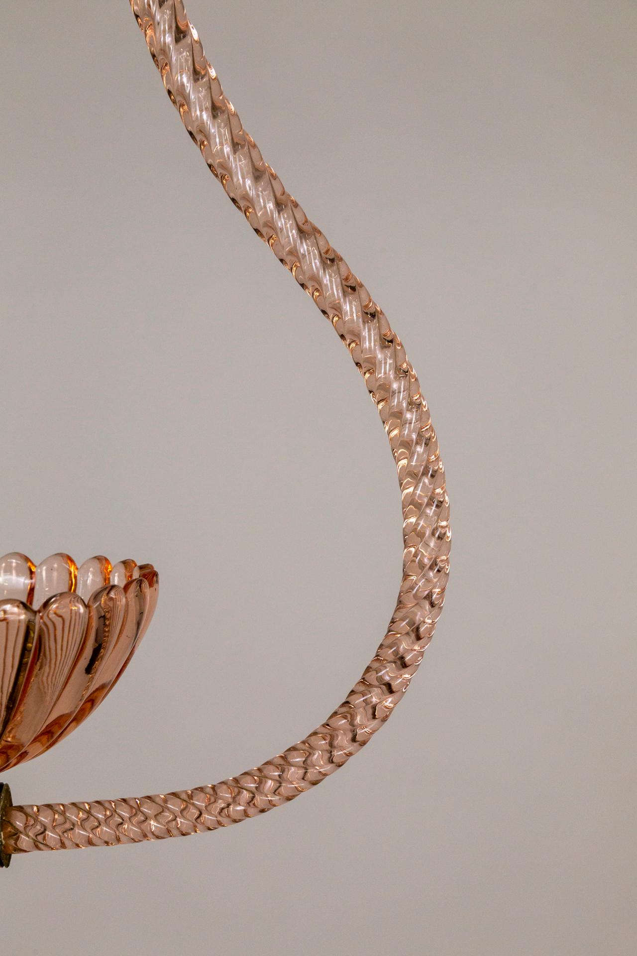 An elegant, modern, Murano glass, pendant light by Barovier & Toso circa 1940-1950. A simple, linear design: translucent pink, twisted-rope stem and frame holding a flora bowl up-light. With bronze-toned, brass canopy and bands connecting the frame
