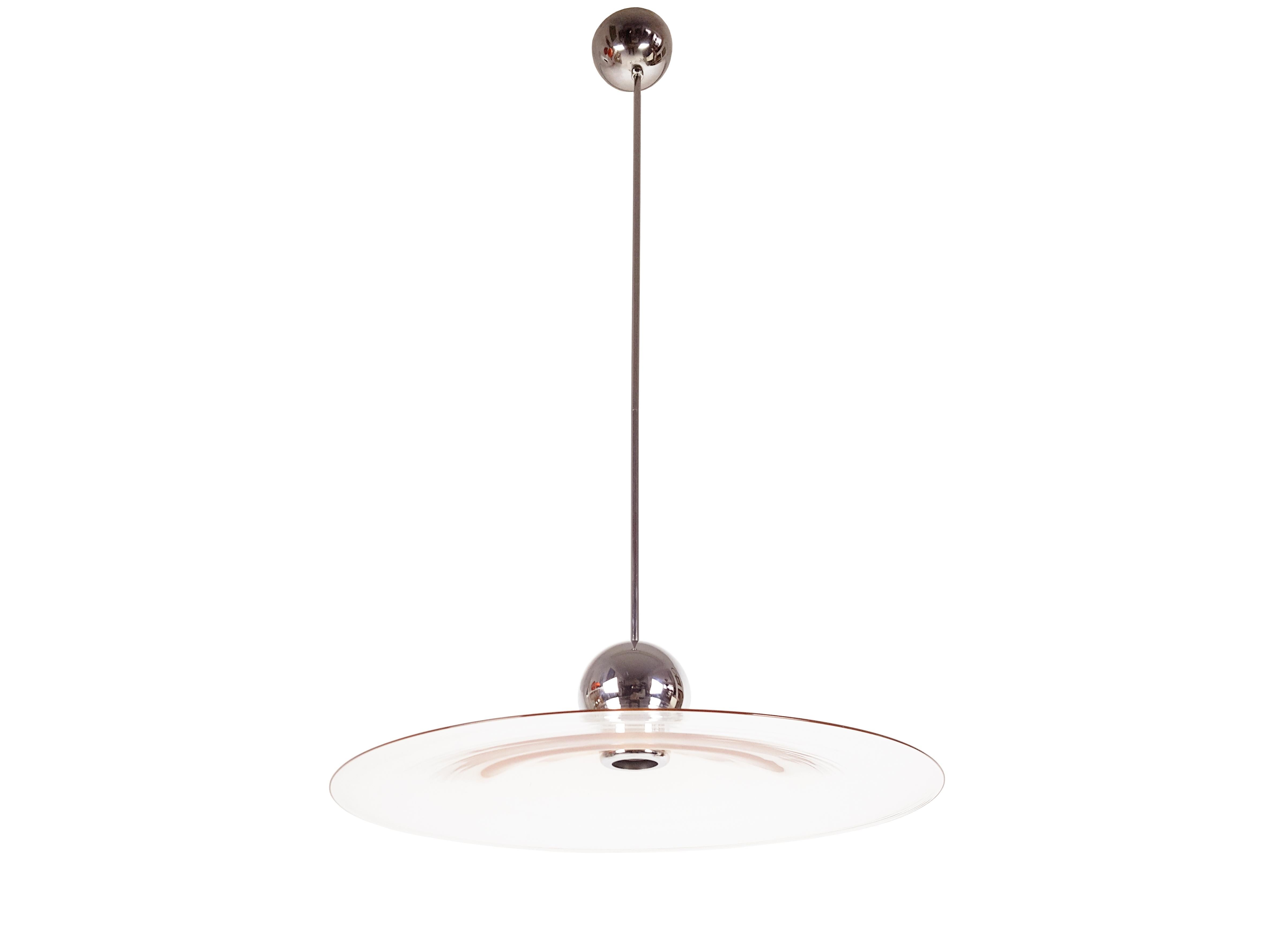 This elegant and light pendant was produced in Italy, circa 1970.
It is made from a thin chrome-plated brass structure and an handmade pink Murano glass round conic shade. The rod, which is made up of 2 parts, is quite long and can be shortened by