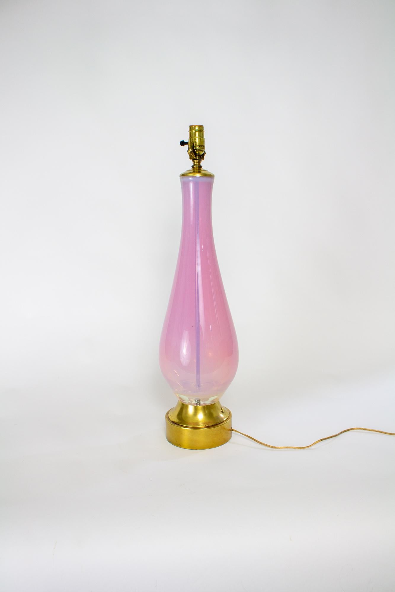 Large pink blown glass table lamp. Smooth Clear and Pink Glass in an extended teardrop shape. Original Brass base. Completely Rewired and Restored.

Dimensions: 
Height: 27