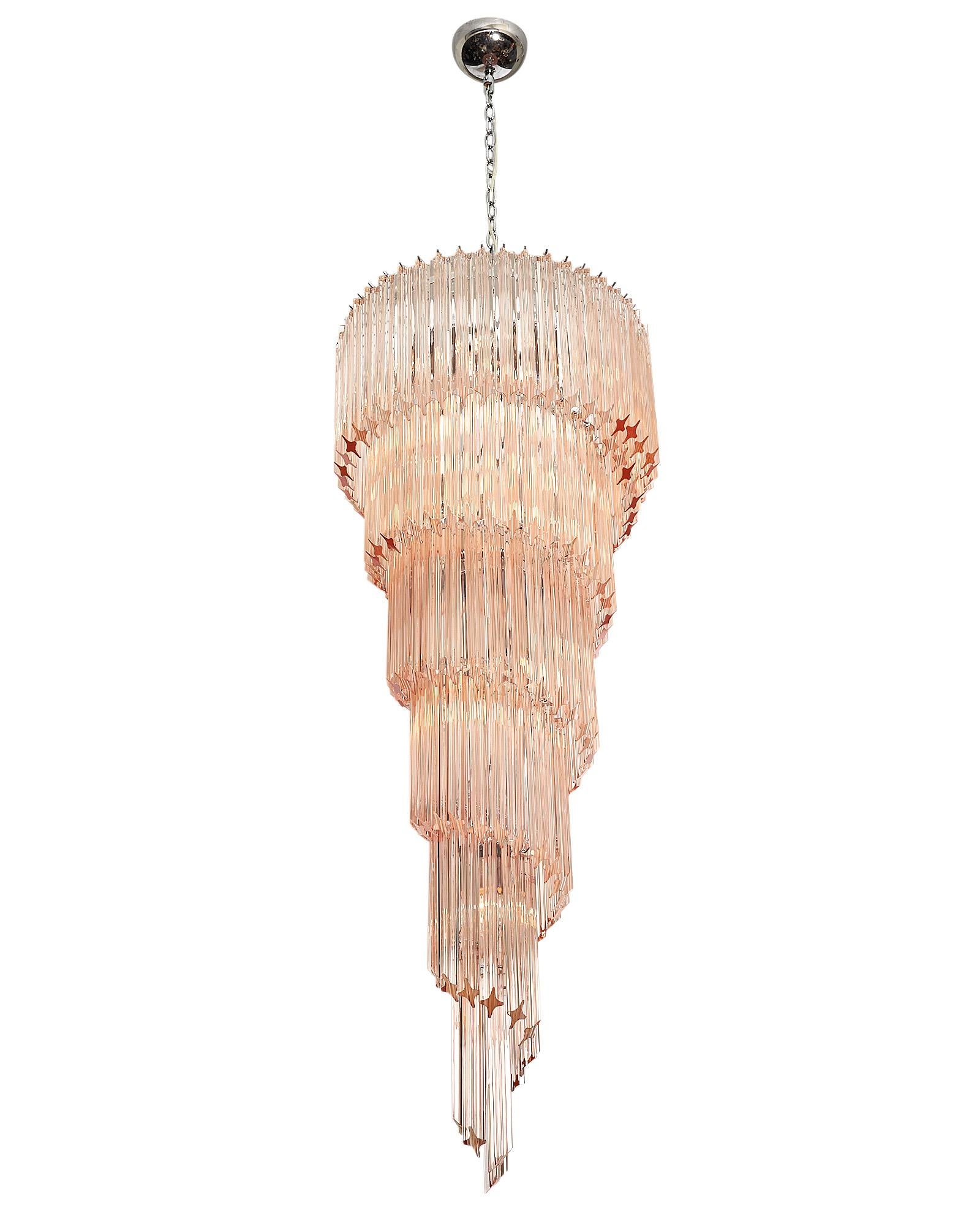 Pink Murano glass Venini “triedri” spiral chandelier. This piece by Venini is in the iconic “spirale triedri” shape and features beautiful hand-blown glass components in a pink hue. They glass is layered in a downward spiral on a chromed structure.