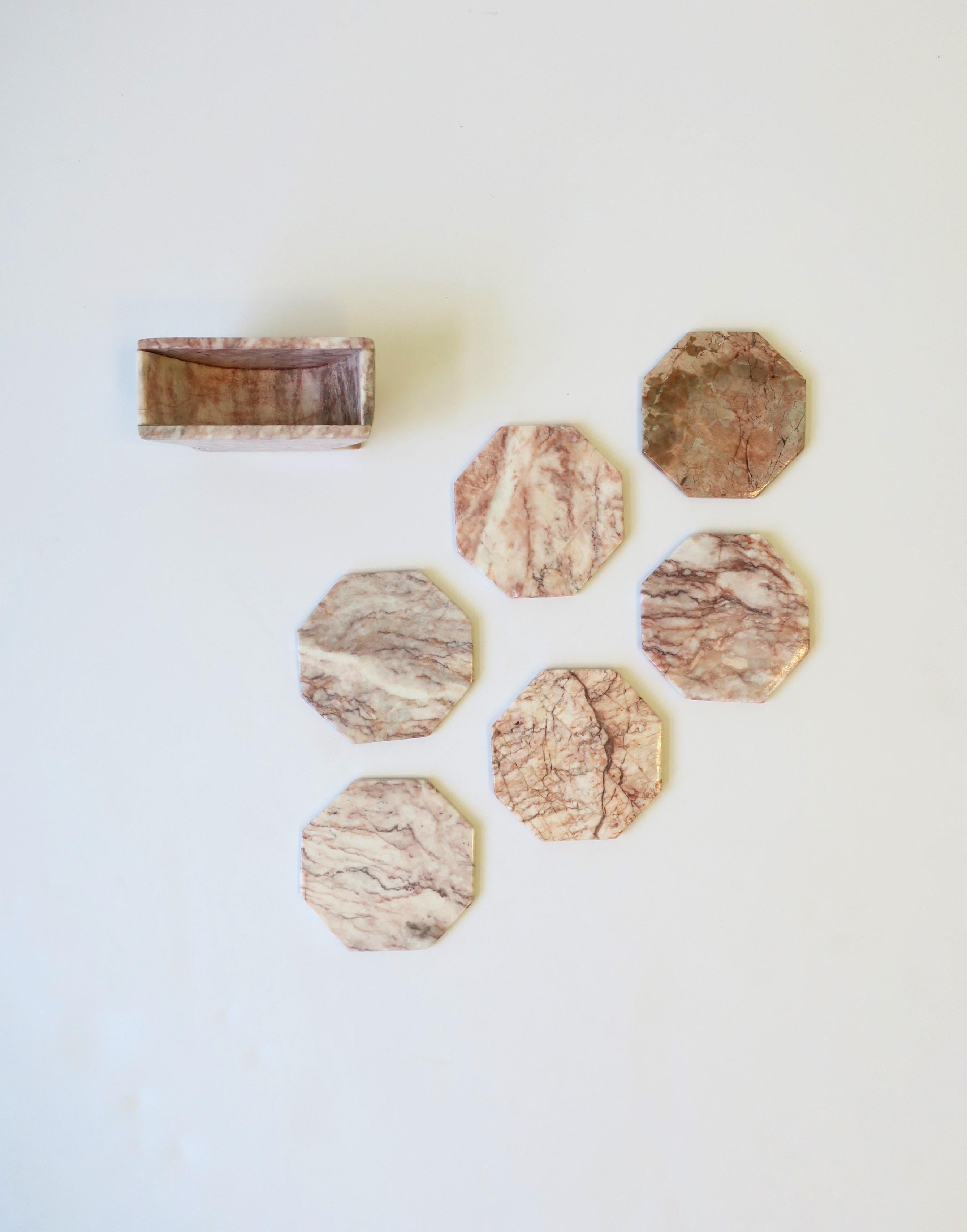 A set of pink marble octagonal shaped coasters with holder in the Modern style, circa 1970s. Set includes 6 coasters and 1 holder. Coasters are great for any drink including Champagne, wine, water, a cocktail, etc., and are essential to protecting