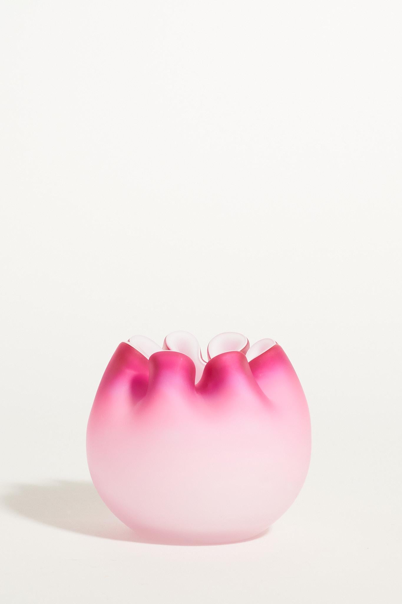Ombré dark to light pink round matte glass vase with ruffled mouth.