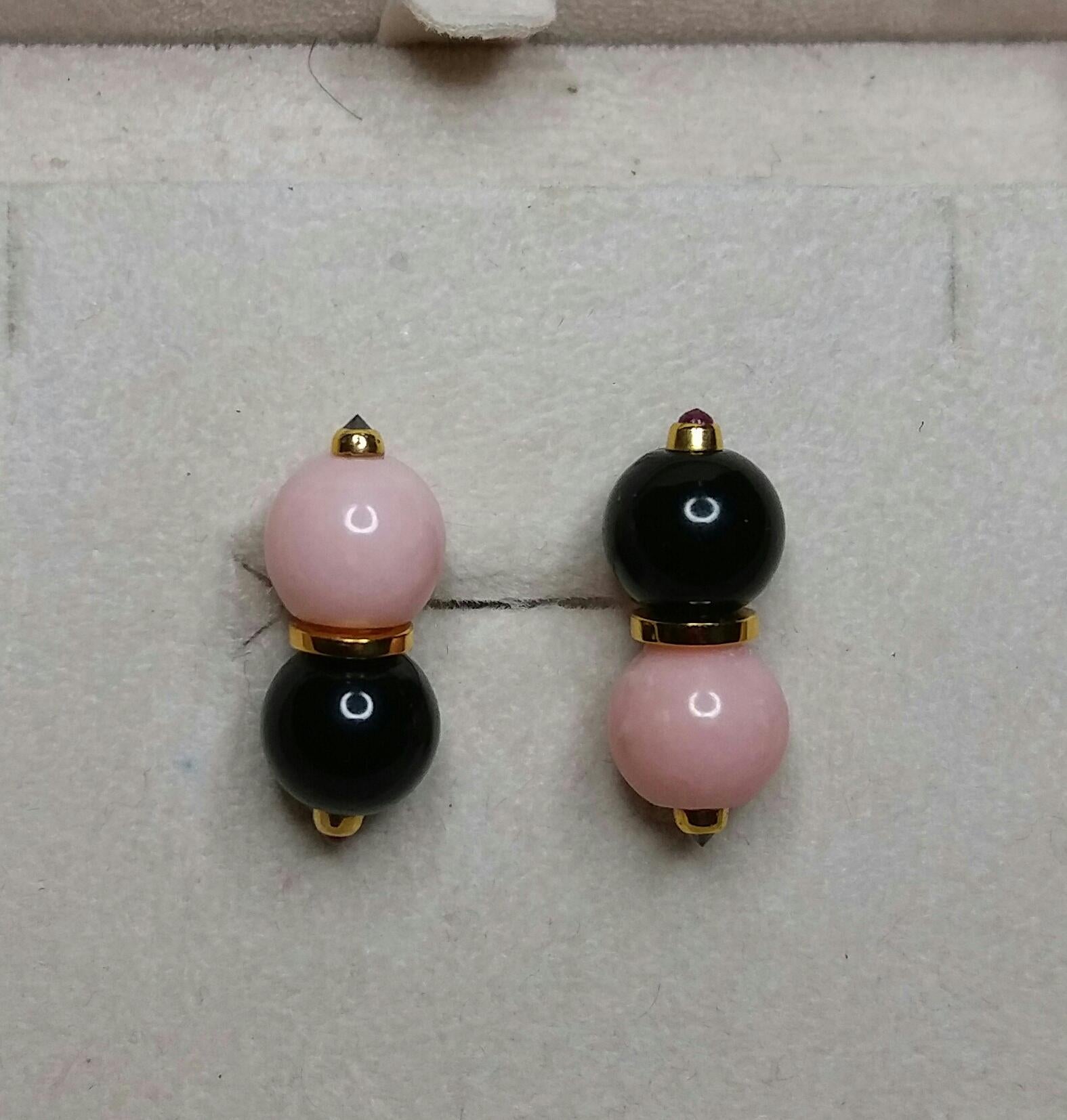 Unique and elegant Art Deco Style earrings composed of a flat ring in solid 14 Kt yellow gold  with 2 round black onyx beads  with 2 small faceted rubies set on one side and 2 pink opal beads with in the center 2 small faceted black diamonds set in