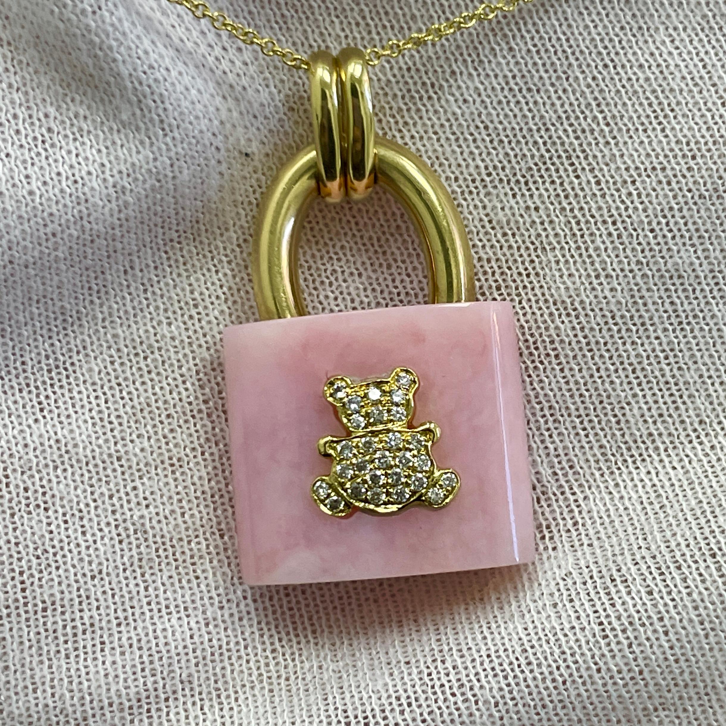 Pink opal and 18K yellow gold lock shape with 0.16Ct of diamond crusted teddy bear. Perfect gift any young lady's birthday, graduation or even having a baby.