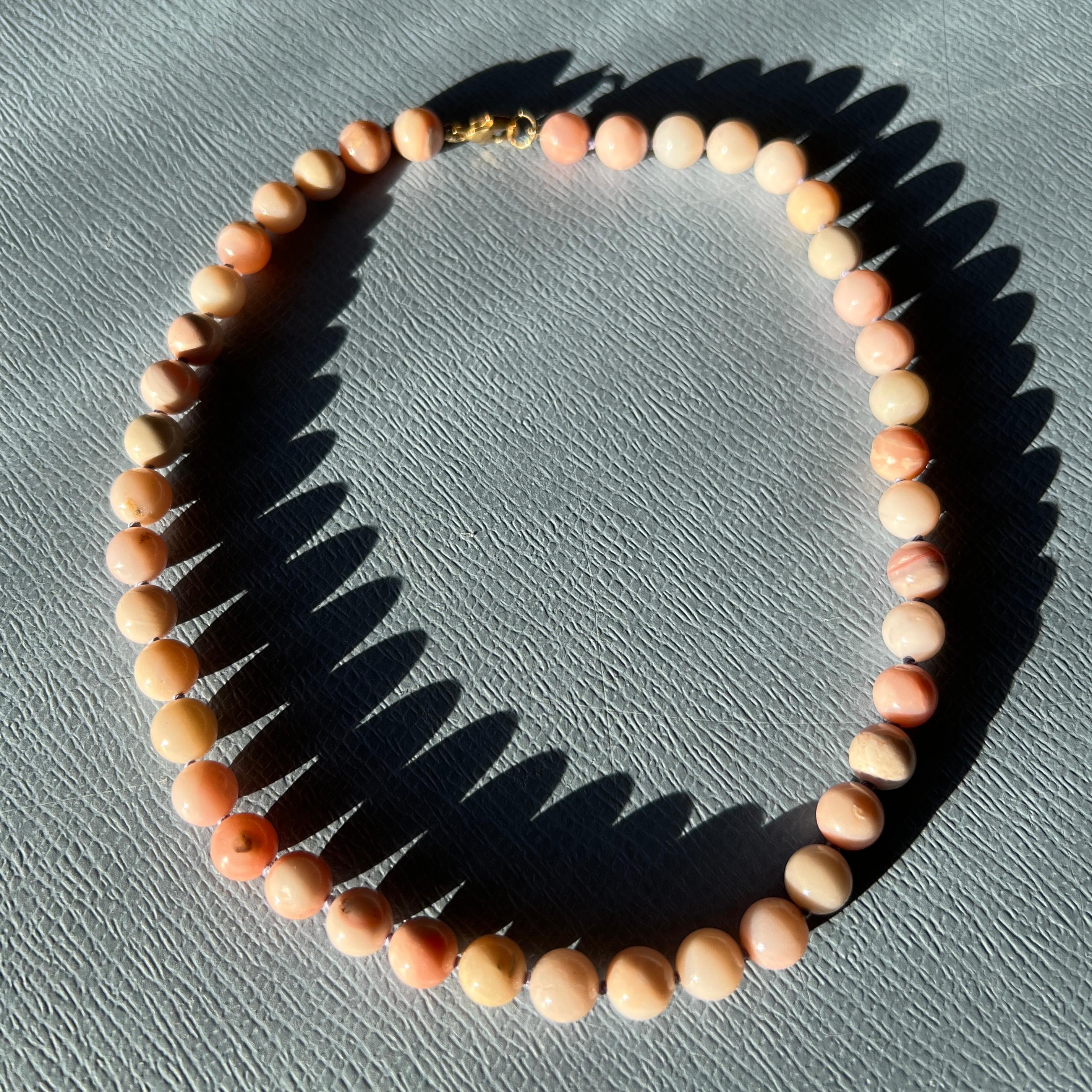 This pink opal choker necklace by J Dauphin is handcrafted in Los Angeles and designed to sit gently at the base of the neck. Measuring 38 cm (15 inches), it offers a delicate yet powerful expression of emotional healing and softness.

Pink opal is
