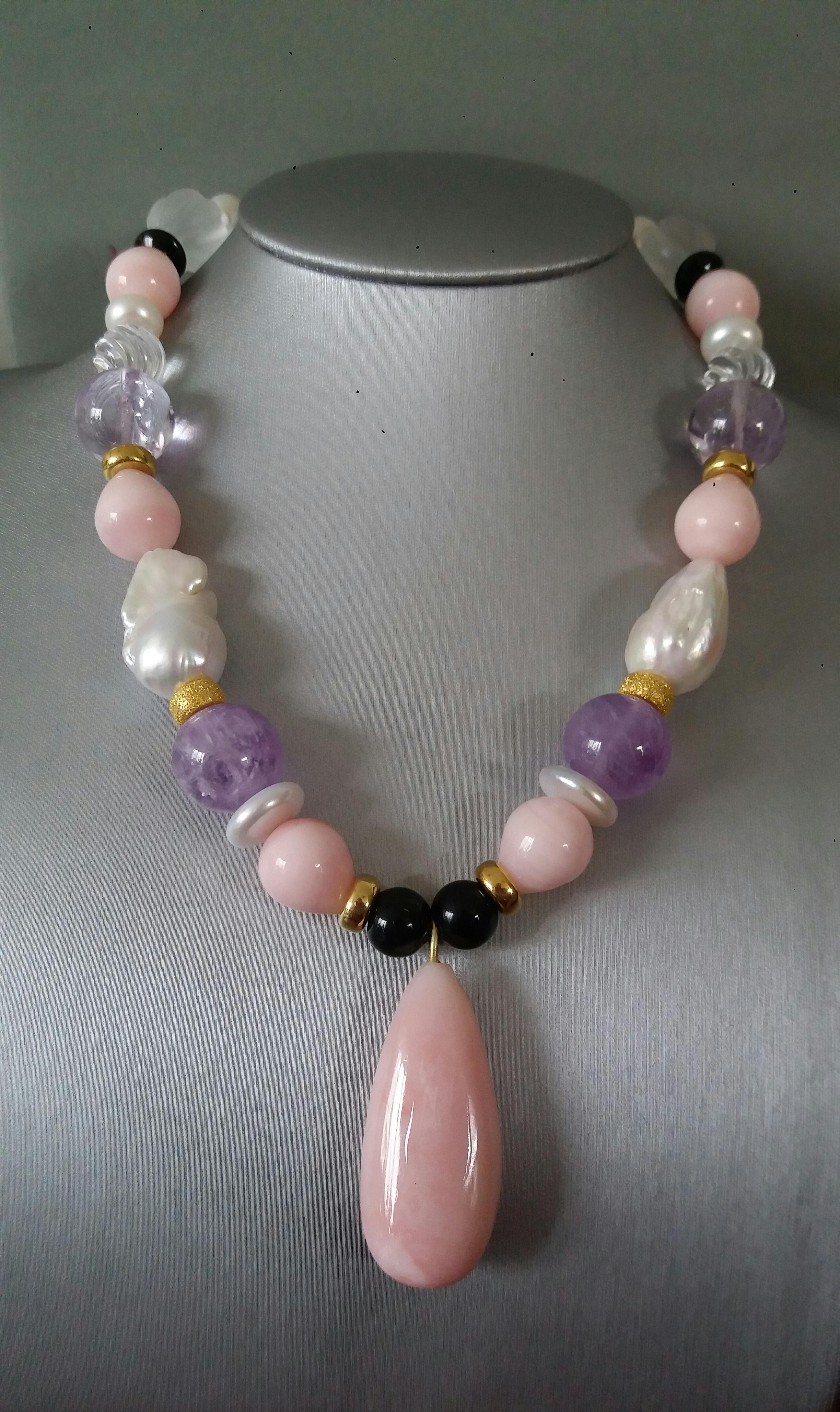 Unique and classy Necklace composed of big size Baroque Pearls, Round Drop Shape Pink Opal,Amethyst spheres of 16 mm, Engraved Quartz beads , Black Onyx 16 mm beads, 14 kt Yellow Gold elements, from which hangs a plain Pink Opal  Pendant  measuring