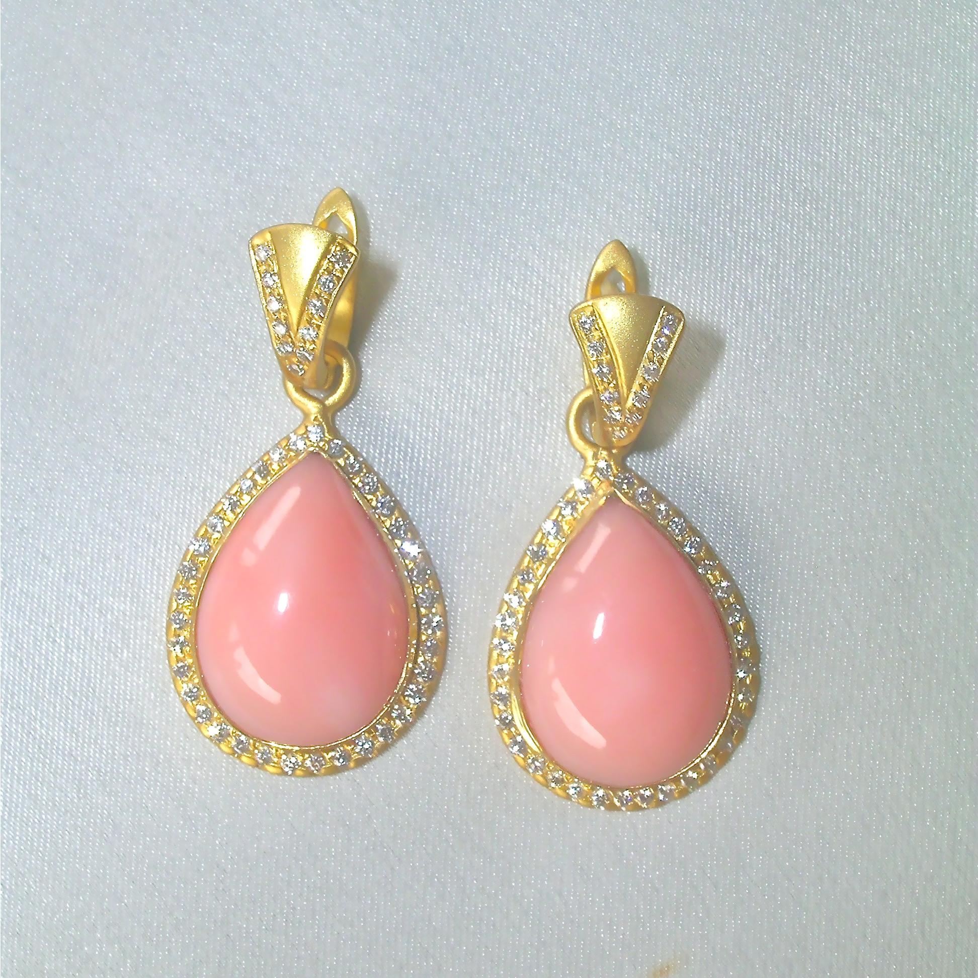 Pink Opals are quite beautiful.  This pair is set with diamonds around in satin finished 18k Gold.
Great for everyday or evening, always part of Nancy's designs.