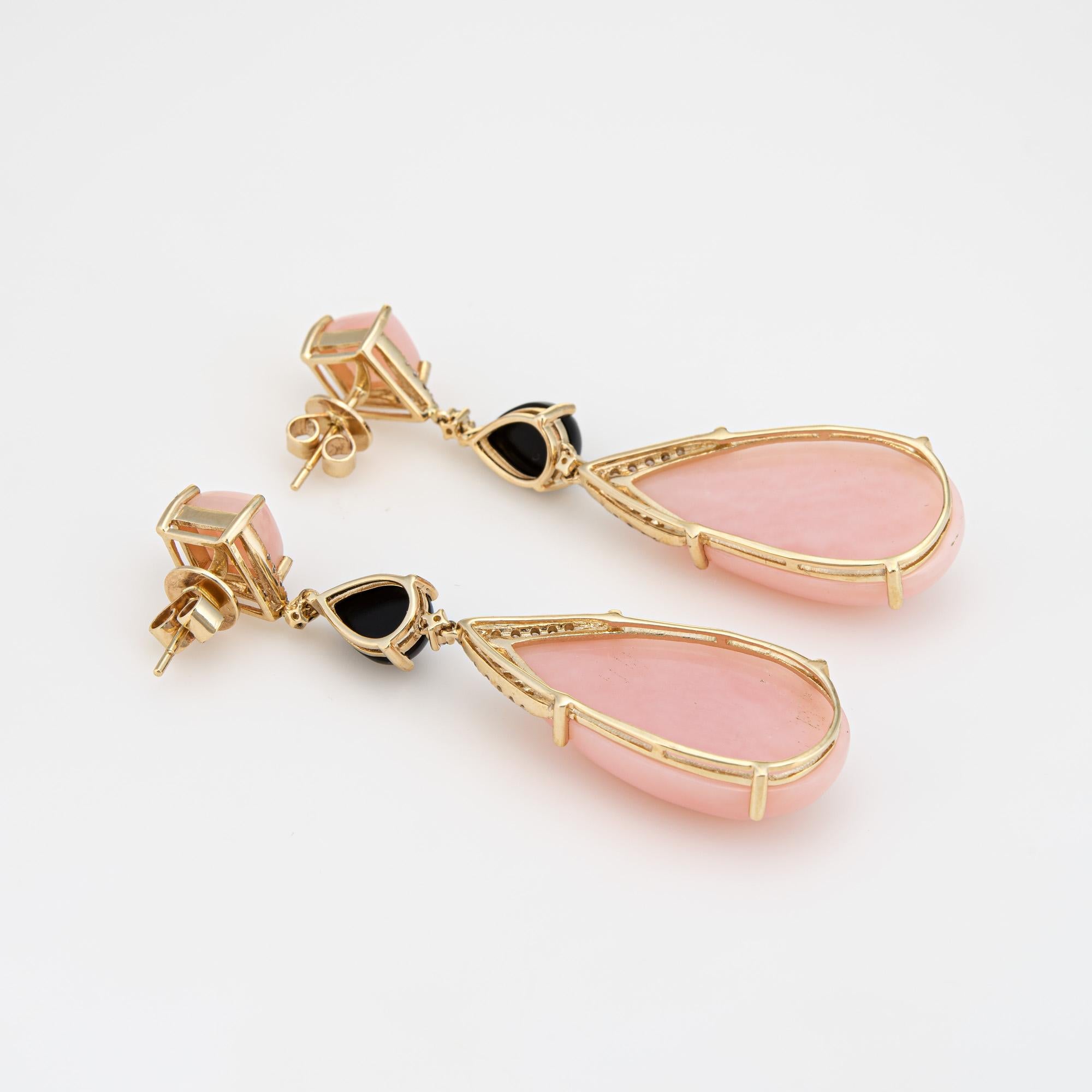 Stylish pair of contemporary pink opal, onyx & diamond drop earrings crated in 14k yellow gold. 

Pink opals measure 8mm (upper) and 26mm x 15mm. Onyx measures 8.5mm x 6.5mm. Diamonds total an estimated 0.20 carats (estimated at I-J color and SI2-I1