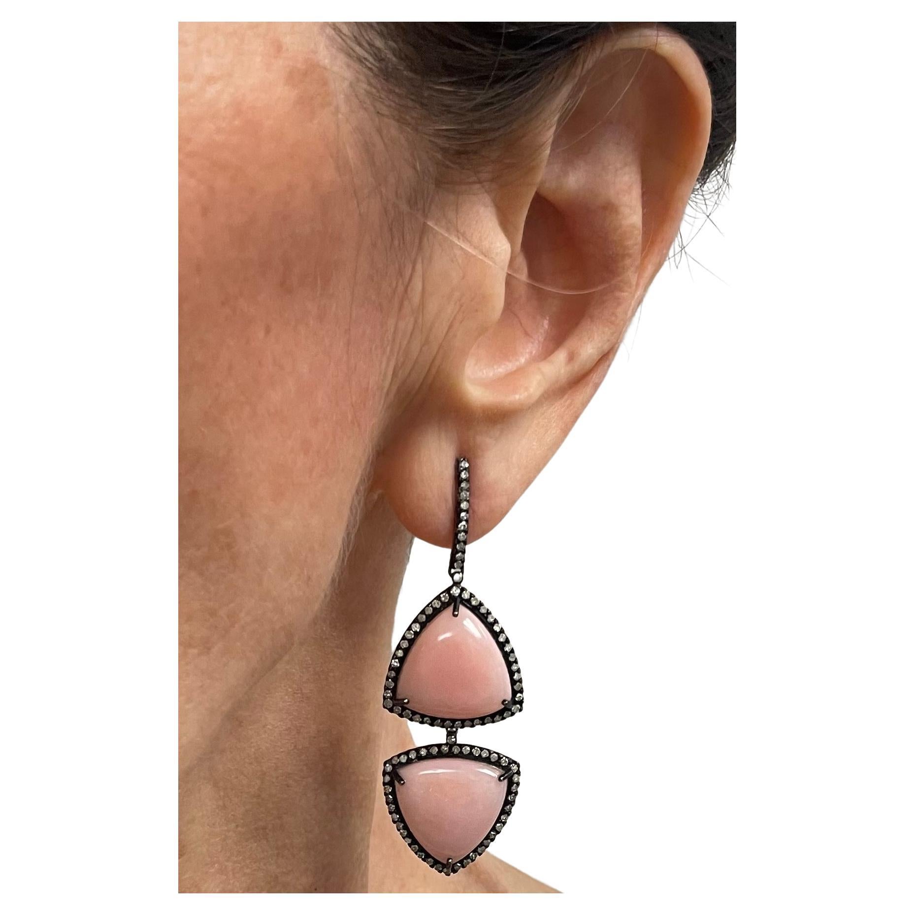 Description
The geometrically shaped pink opal, framed with pave diamonds set in a black background, creates a stylish contrast and an impressive statement. 
Item #E2850

Materials and Weight
Pink opals 30cts
Pave diamonds 1.62cts
Rhodium sterling
