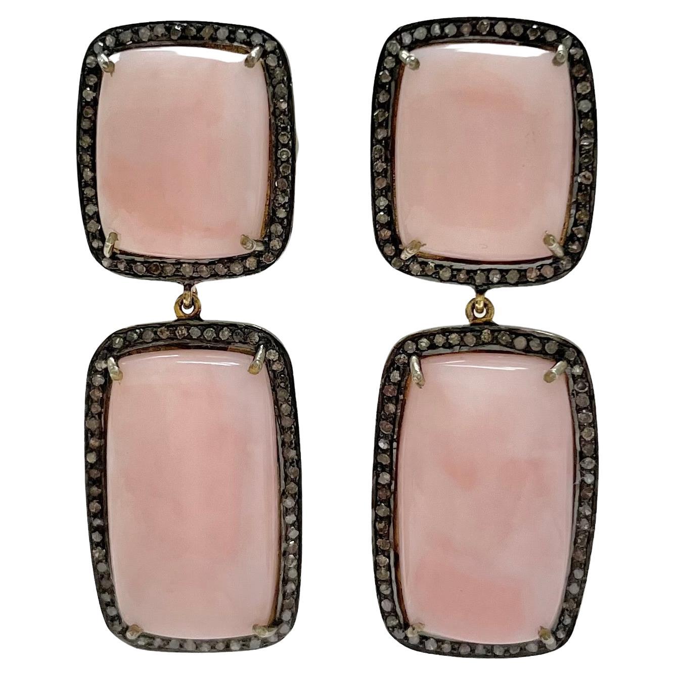 Description
The geometrically shaped pink opal, framed with pave diamonds set in a black background, creates a stylish contrast and an impressive statement. 
Item #E2421

Materials and Weight
Pink opals 44cts
Pave diamonds 1.32cts
Vermeil
14k yellow