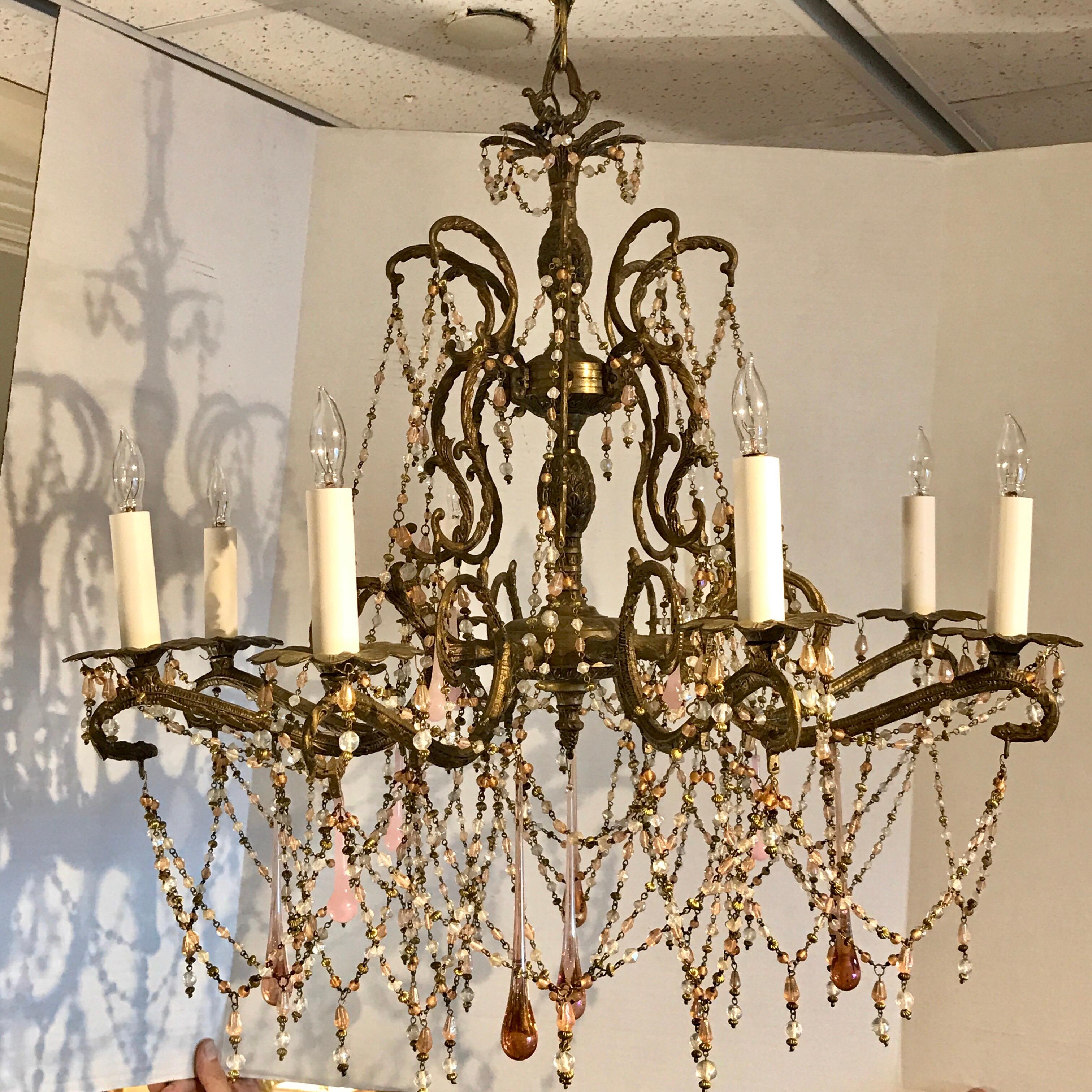 Pink opaline eight-light brass chandelier, with numerous delicate colored prisms. Newly wired.