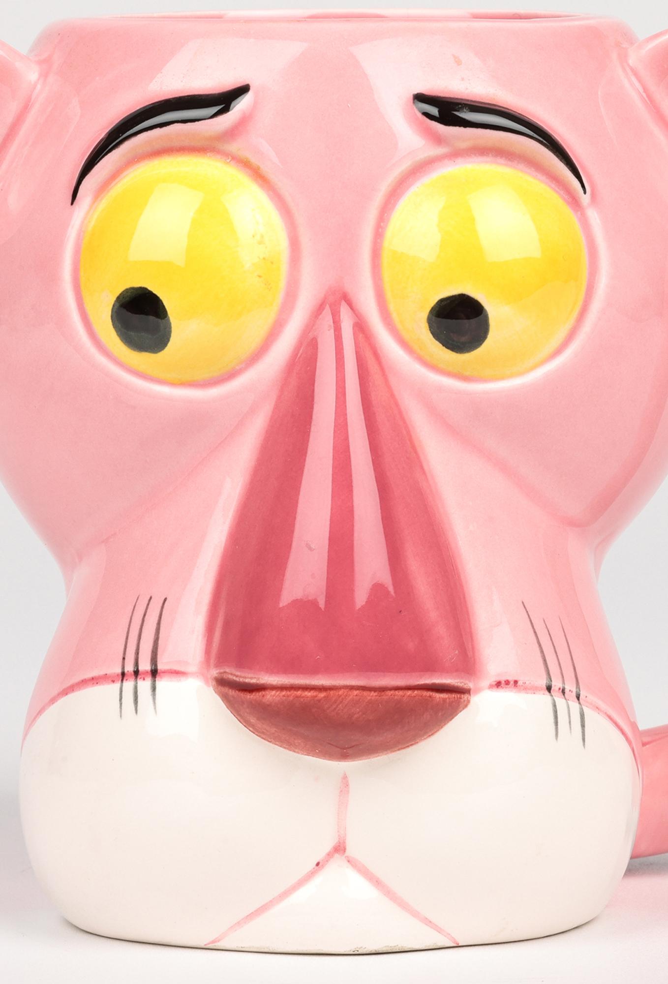 A delightful, Japanese licensed Pink Panther Collection character mug formed as the head of the Pink Panther distributed by Royal Orleans and dated 1981. The ceramic mug is formed as a large, molded head of the Pink Panther with large nose and eyes