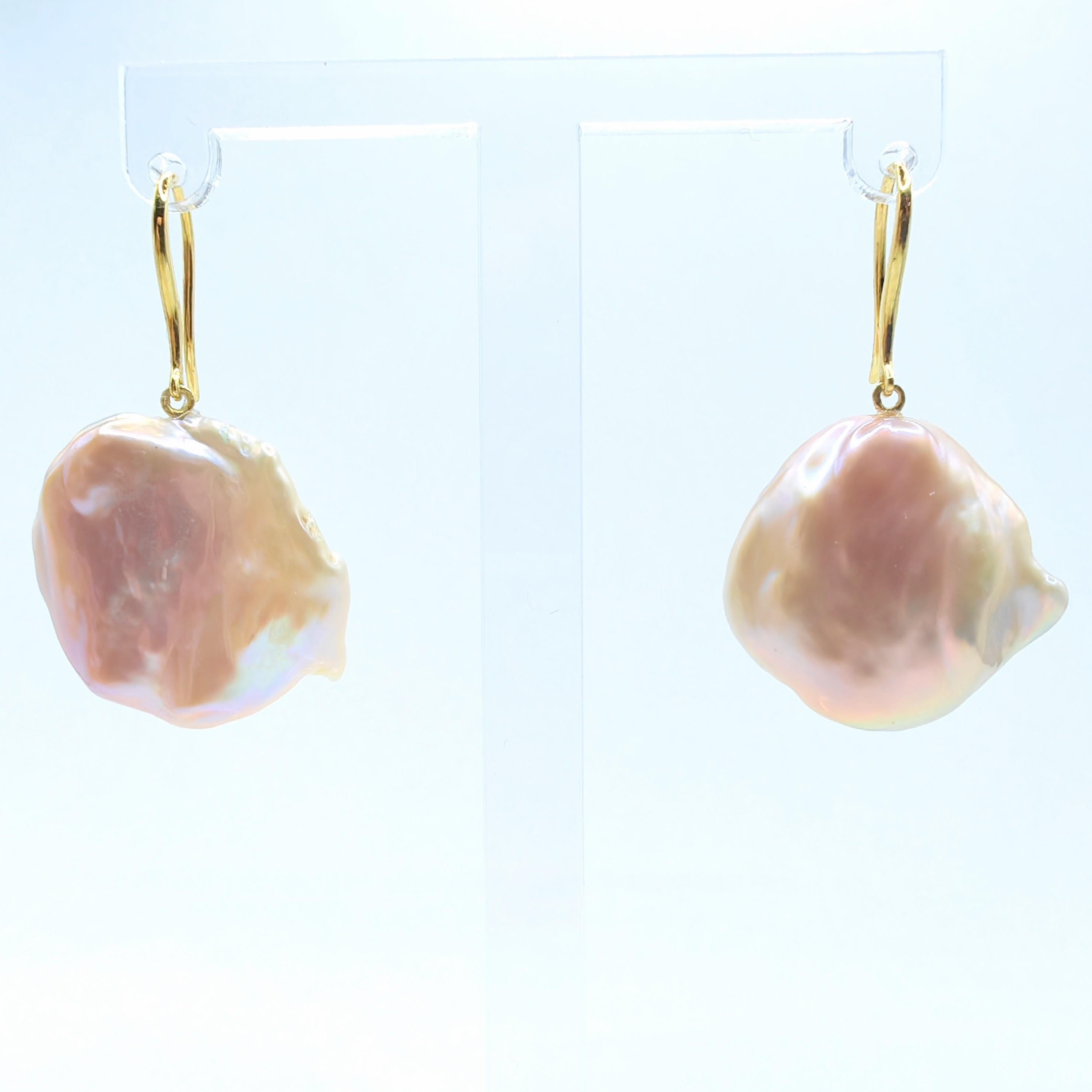 Elevate your look with the ethereal charm of our Pink-Peach Keshi Pearl Dangling Drop Earrings, a celebration of delicate elegance and natural beauty. These exquisite earrings feature lustrous Freshwater Cultured Keshi Pearls, which are formed