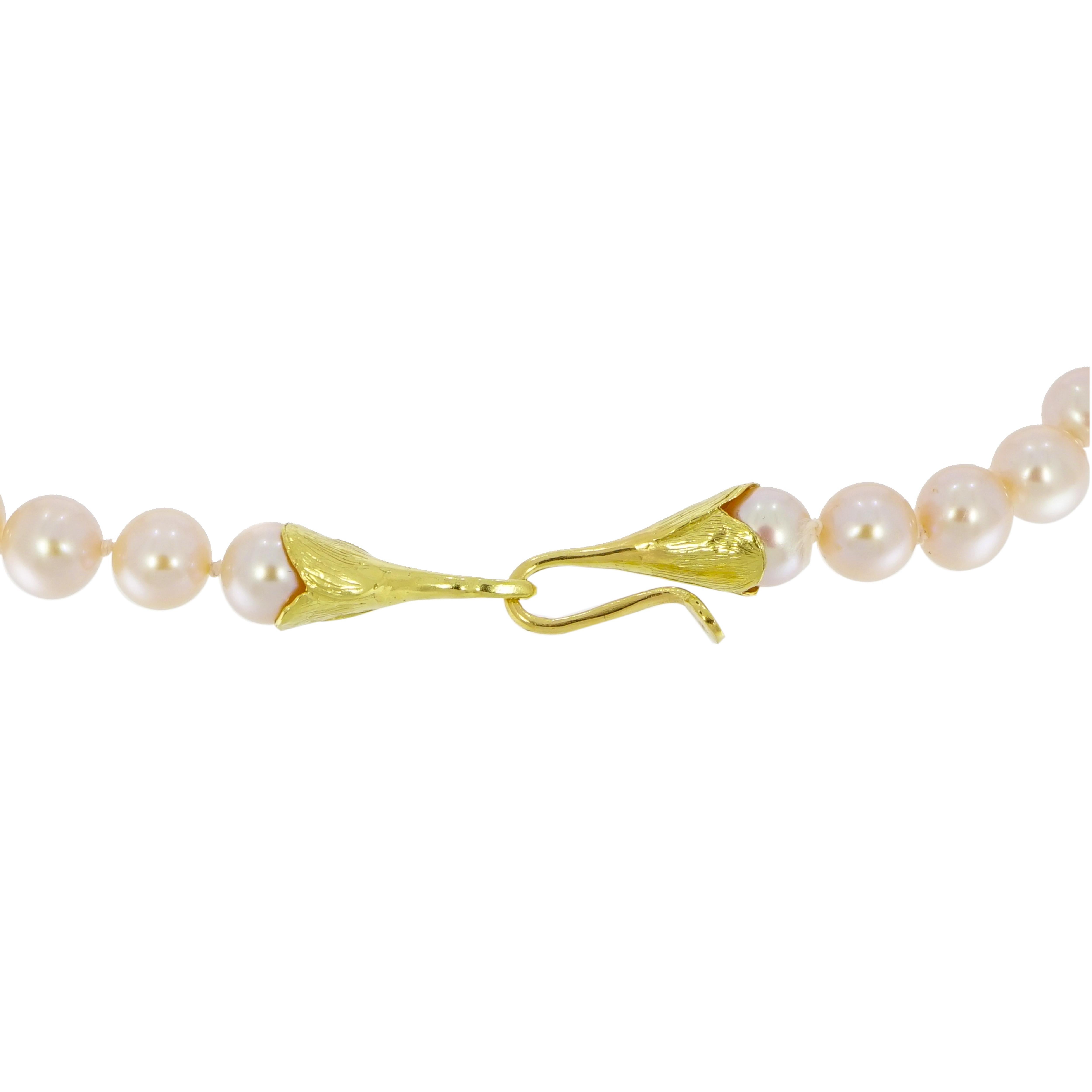 Romantic... Precious and Feminine!!! 
This classic pearl necklace is comprised of 19 inch string of pink with peach overtone pearls and finished with a handmade 18k yellow gold hook style clasp. The pearls are 8-8.5mm in size. 

