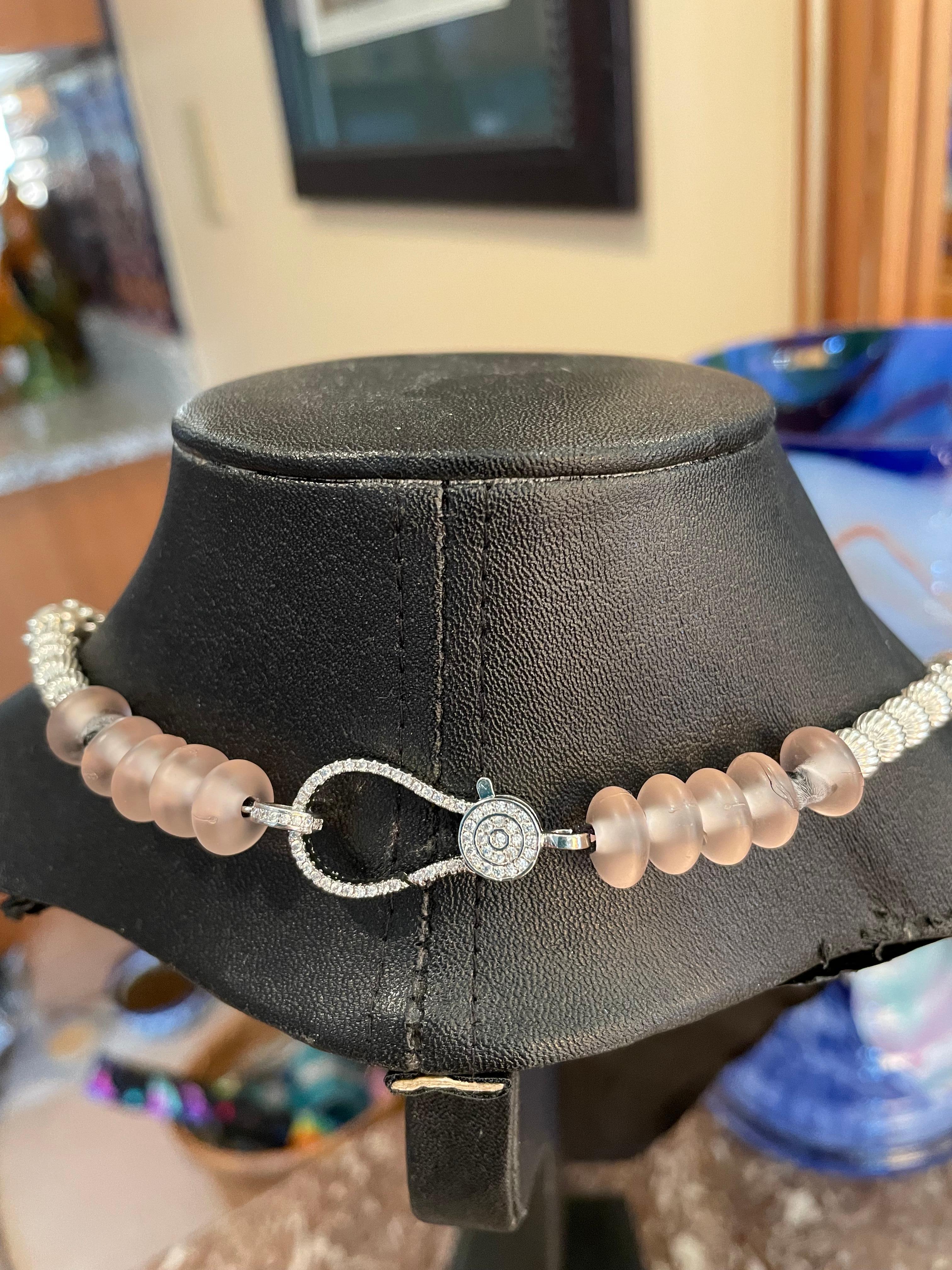 Large freshwater pink pearls,with a vintage Sterling Silver pierced floral pendant is on offer from Lorraine’s Bijoux. This handmade,one of a kind,statement necklace is enhanced with sterling silver beads and a large sterling lobster claw clasp with