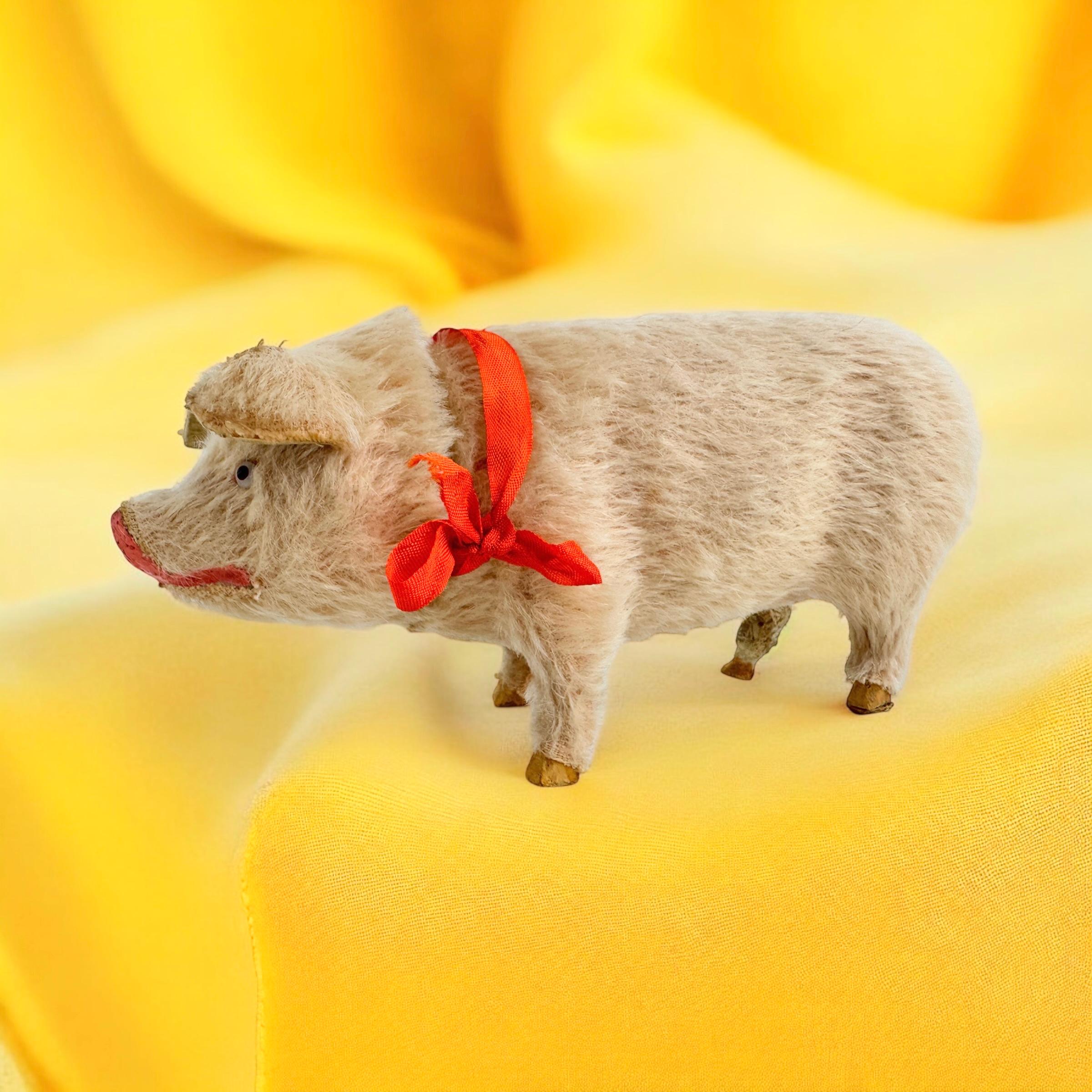 A beautiful pink pig candy container. Made of paper mache, covered with mohair and has glass eyes. Nice addition to your Christmas or new years collection or decoration. It is from the 1900s. Found at an estate sale in Vienna, Austria.