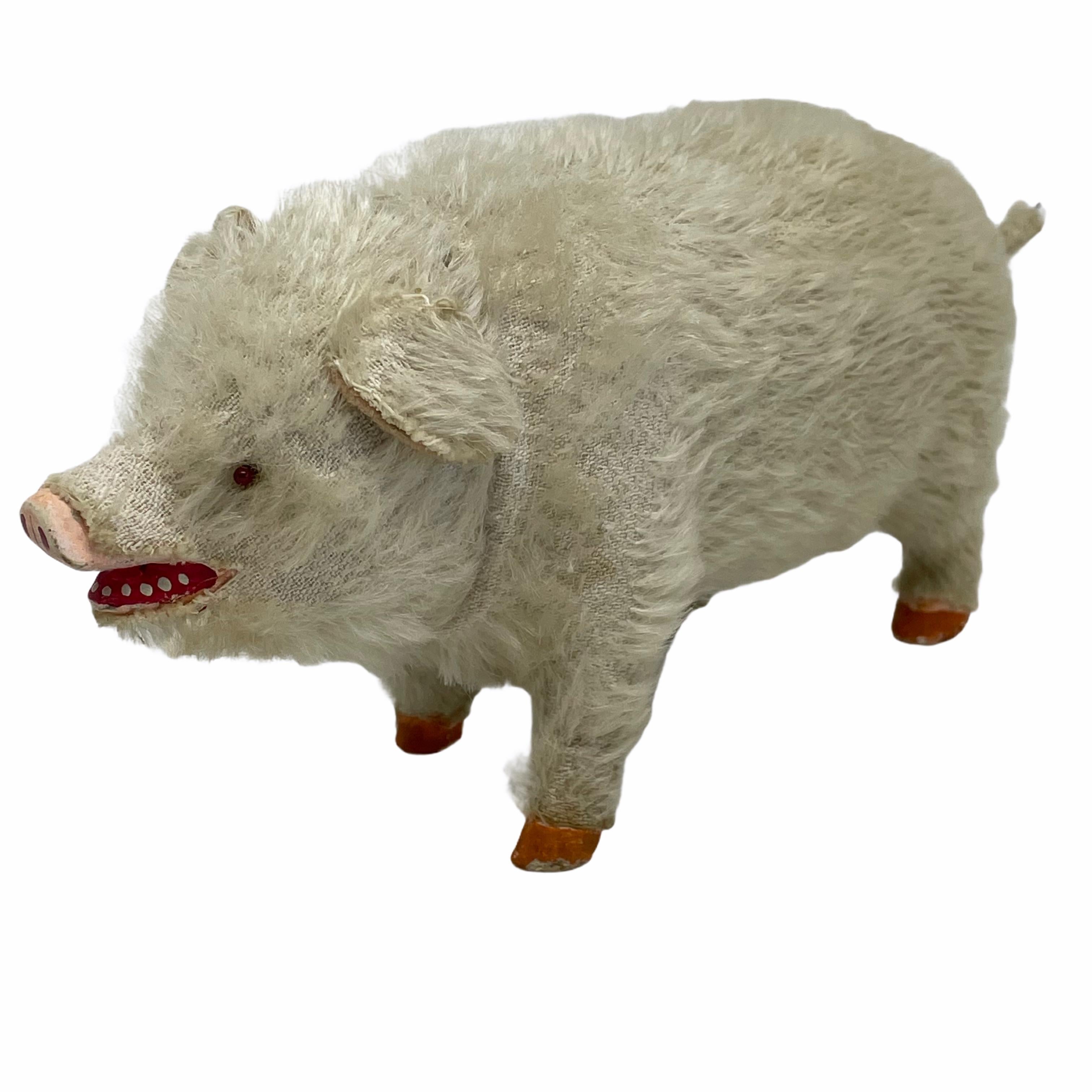 A beautiful pink pig candy container. Made of paper mache, covered with mohair and has glass eyes. Nice addition to your Christmas or new years collection or decoration. It is from the 1900s. Found at an estate sale in Vienna, Austria.