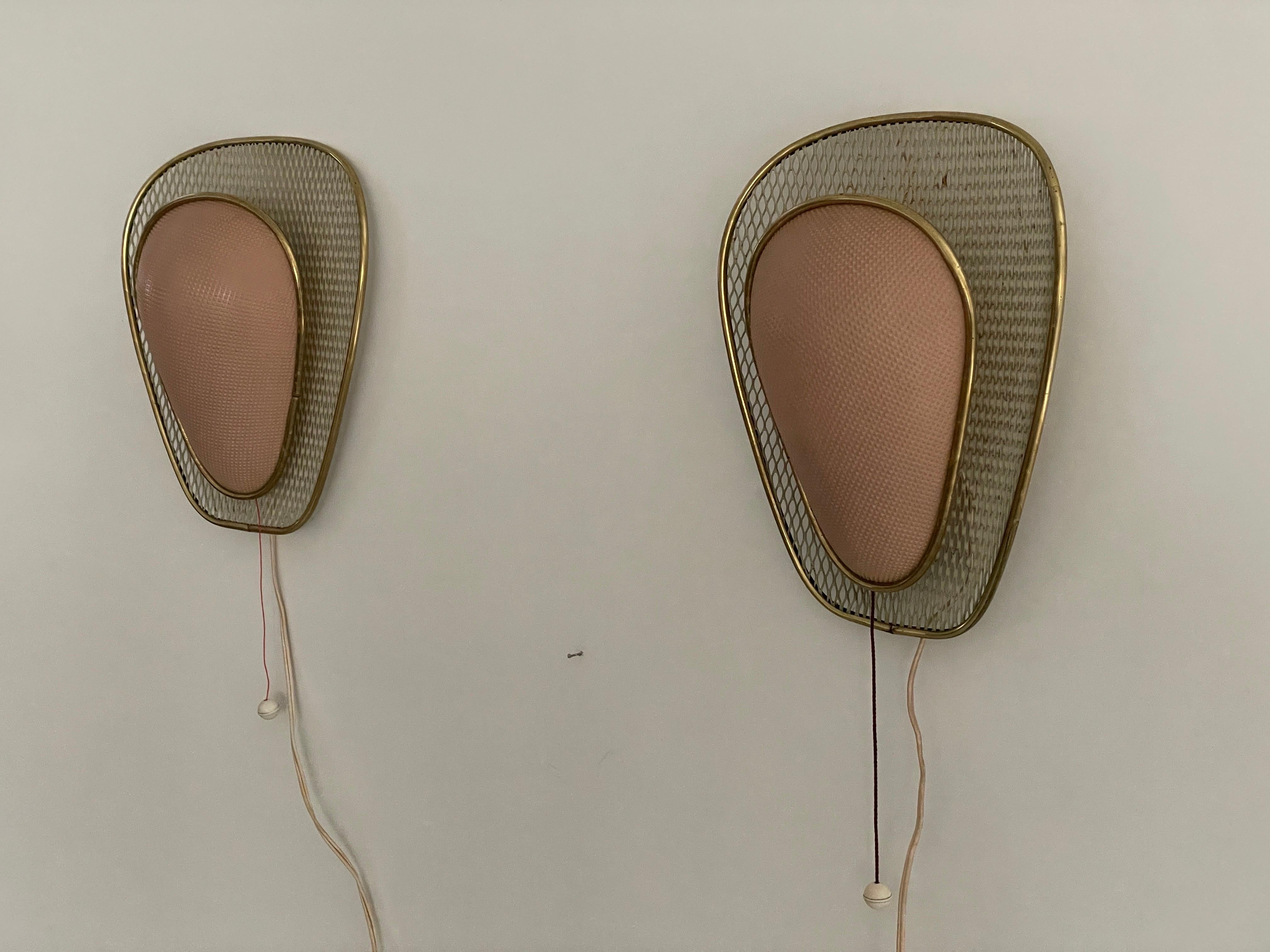 Pink Plastic and Gold Metal Pair of Sconces by Erco, 1950s, Germany

Lampshade is in very good vintage condition.

This lamp works with  E27 light bulbs. 
Wired and suitable to use with 220V and 110V for all countries.

Measurements:
Height: 29