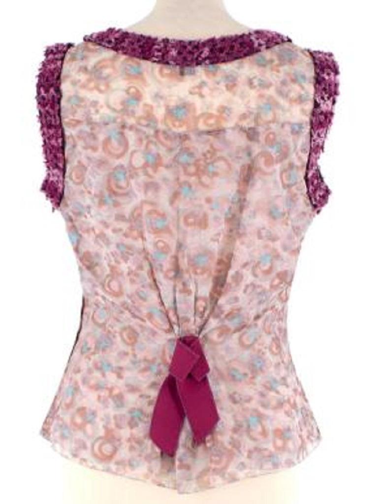 Louis Vuitton Pink & Purple Printed Silk Top
 

 - Sheer silk sleeveless top with abstract floral print
 - Boucle yarn trim in purples and pinks
 - Pleats synched by a woven belt-like panel
 - Woven bow on the back
 - Semi-sheer double layer silk