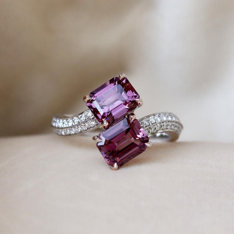One of a kind Toi et Moi ring handmade in Belgium and handmade the traditional way ( no casting or printing involved ). Set with 2 Emerald cut Pink Purple Spinels and pave set Brilliant-cut white diamonds on the ring shank. The ring is made in 18K