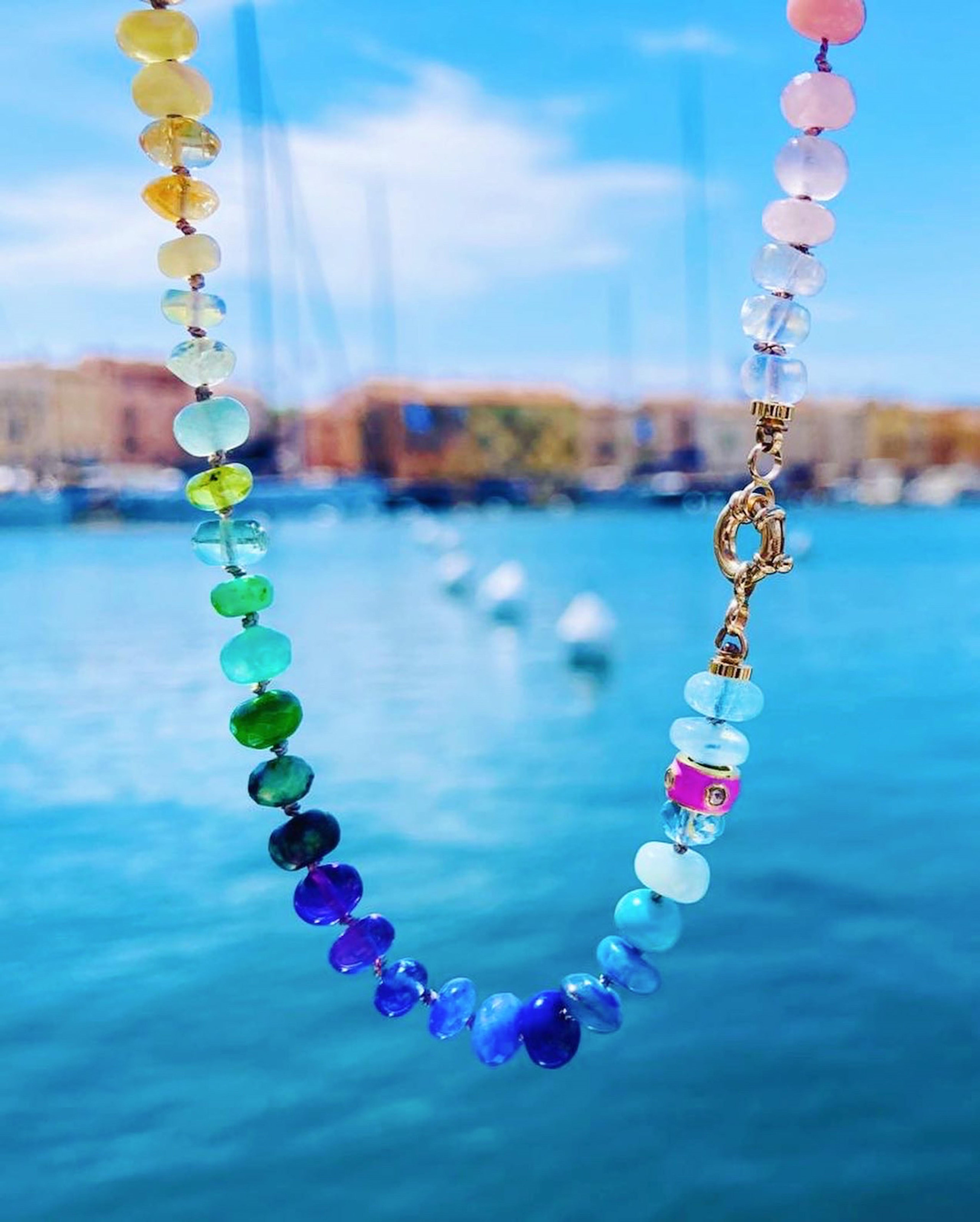 This vibrand hand made rainbow gemstone necklace includes polished bright multi-colored  gemstones, such as: 

• Pink Sapphire
• Ruby
• Peruvian Amazonite
• Garnet
• Swiss topaz
• Tanzanite
• Chrome Diopside
• Emerald
• Ethiopian opal
• Australian