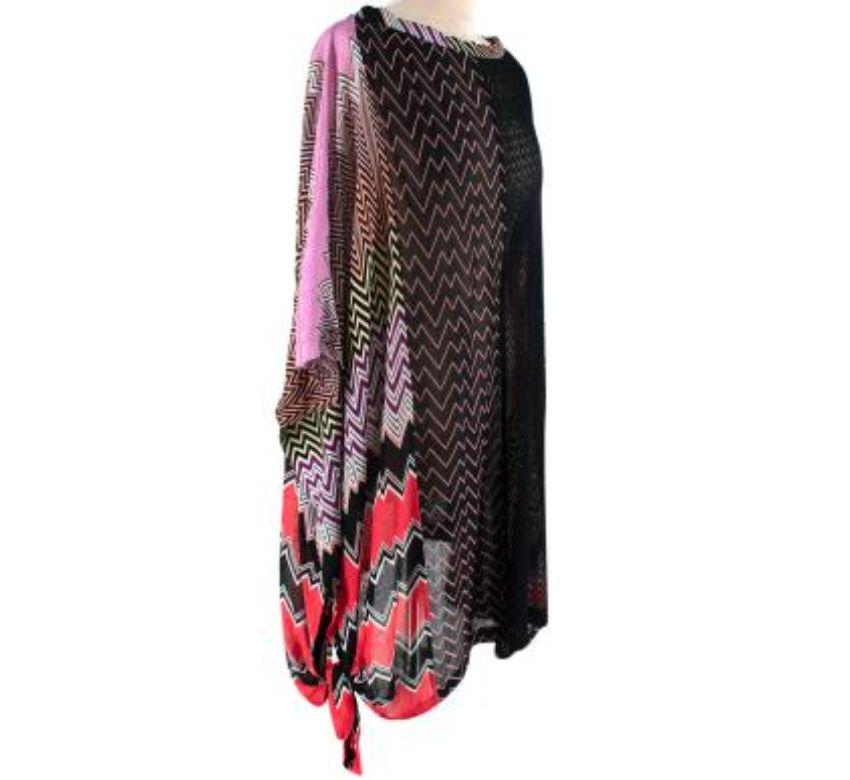 Missoni Pink, Red & Black Knitted Tunic Dress
 
 - Longline knitted tunic featuring panels of pink and red chevrons and a black semi-sheer body
 - Large bateau neckline 
 - High-low hemline with tie side
 
 Materials:
 This item does not have a care