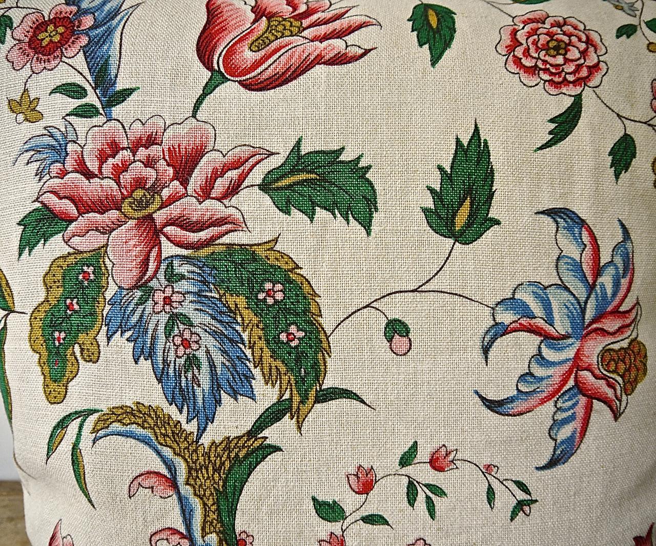 Mid-20th century, French hand printed linen cushion printed with large scale design of stylized exotic flowers and leaves in raspberry red and pink and blueson meandering branches.Self-backed and slip-stitched closed with duck feather cushion pad.