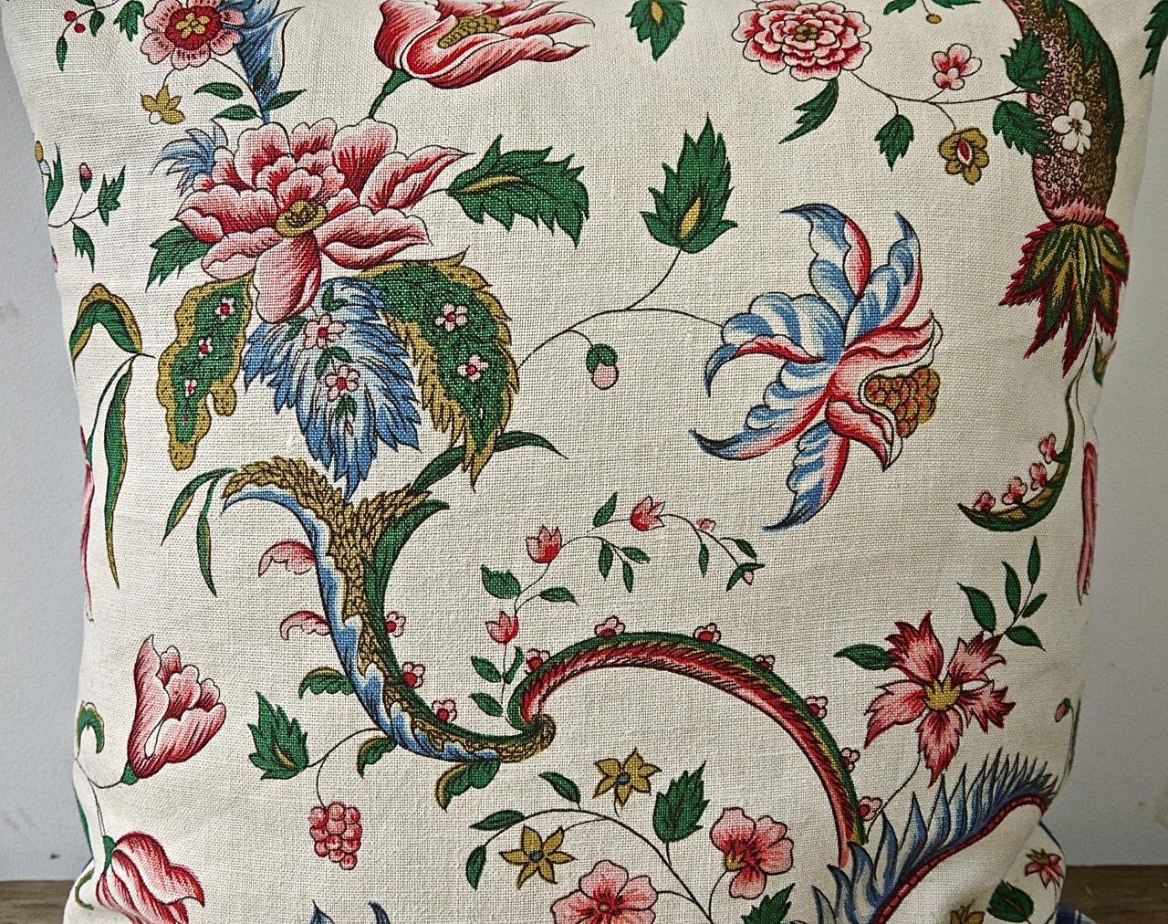 Mid 20th century, French hand printed linen cushion with a large scale design of stylized exotic flowers and leaves in raspberry red and pink and blues on meandering branches.Backed in a 19th century French blue and white cotton check and