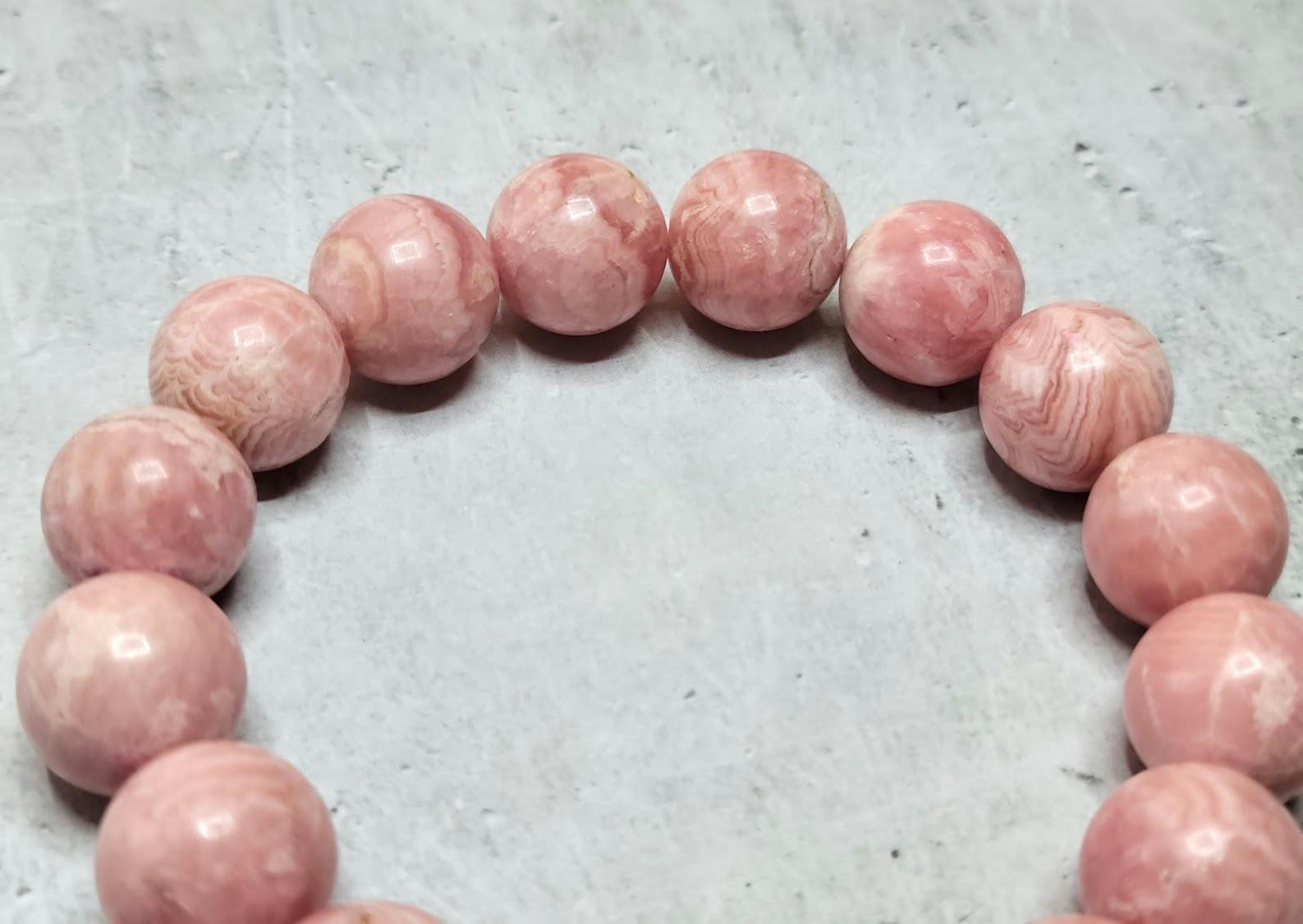 The length of the bracelet is 9 inches (23 cm). The rare size of the smooth round beads is 14 mm.
Natural rose-red rhodochrosite. Authentic, natural color not treated in any way. Superior higher grade! The beautiful, interesting, light pinky matrix