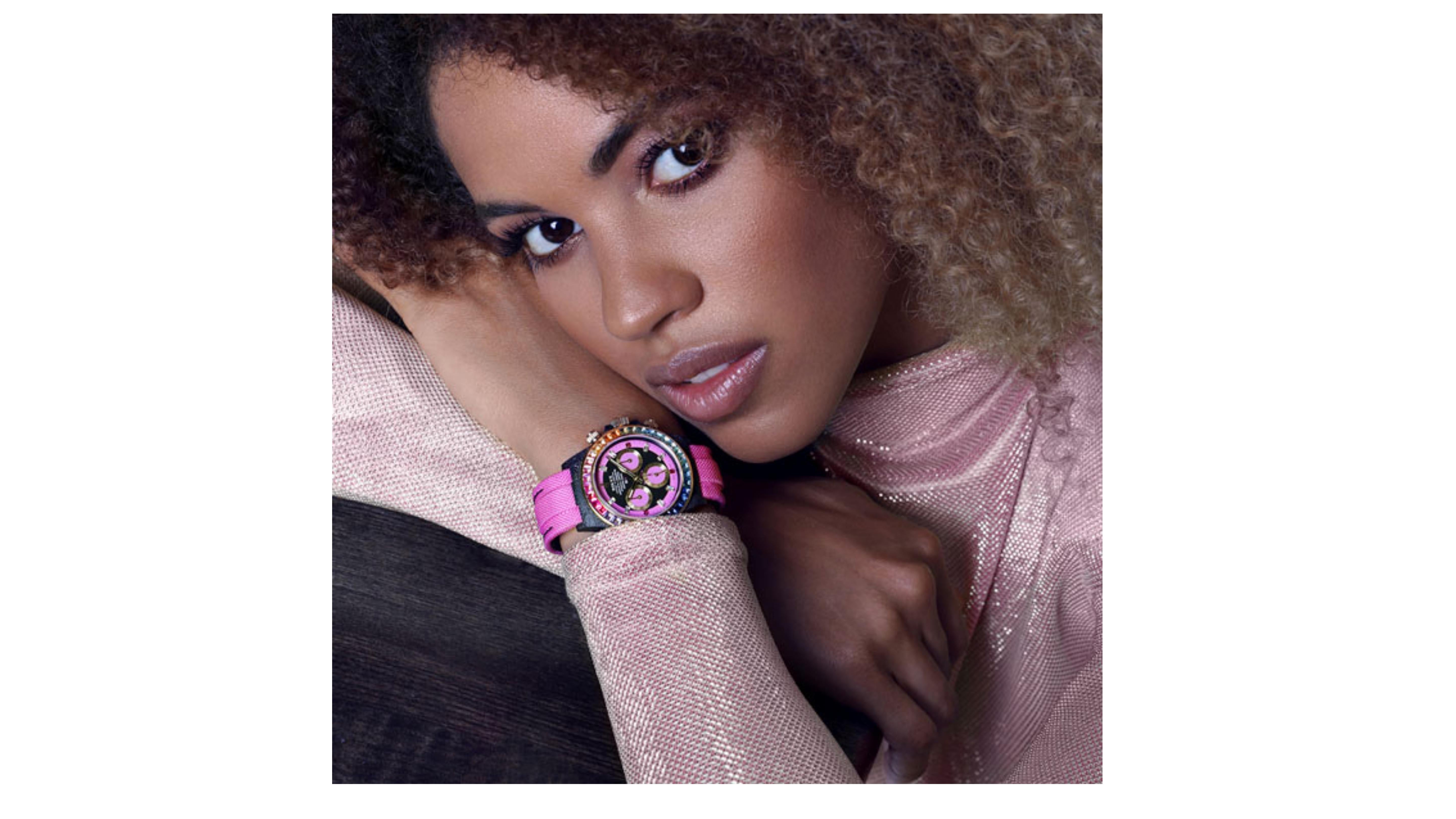 Pink Rolex Daytona Custom Watch 

This Rainbow Pink color would also suite ladies too  and is Carbon Fibre made with unique technology . Anyone who loves pink this is something that will make a impression.    It has Pink and Green Yellow  Blue  Gems