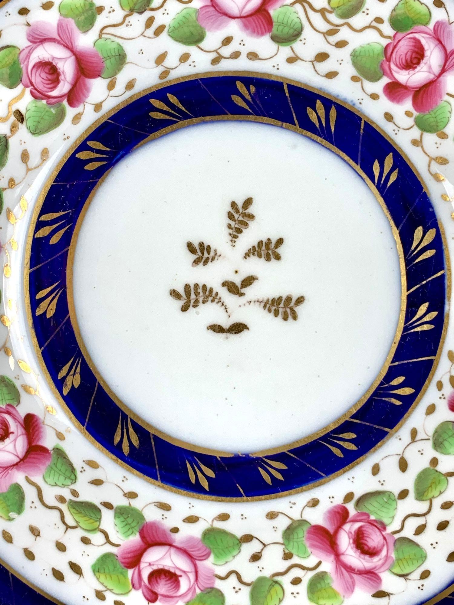 This exquisite antique porcelain saucer dish was hand painted at the renowned New Hall China Works in England circa 1810.
It is a piece of artistry that has gracefully withstood the test of time, carrying a rich history and a captivating story.
The