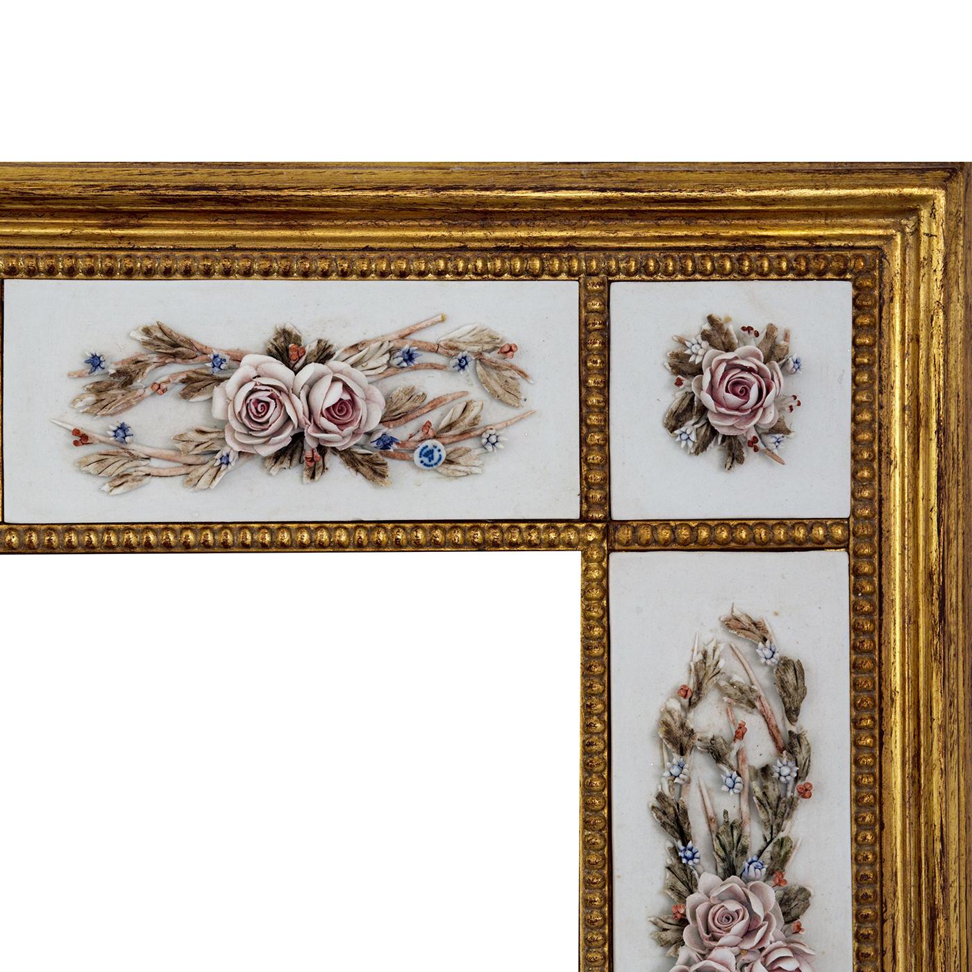 This spectacular mirror is framed with an extraordinary work of art, handmade of wood and splendidly decorated with patinated gold leaf and Capodimonte porcelain applications, painted by hand with gorgeous roses and rose buds cooked on a third