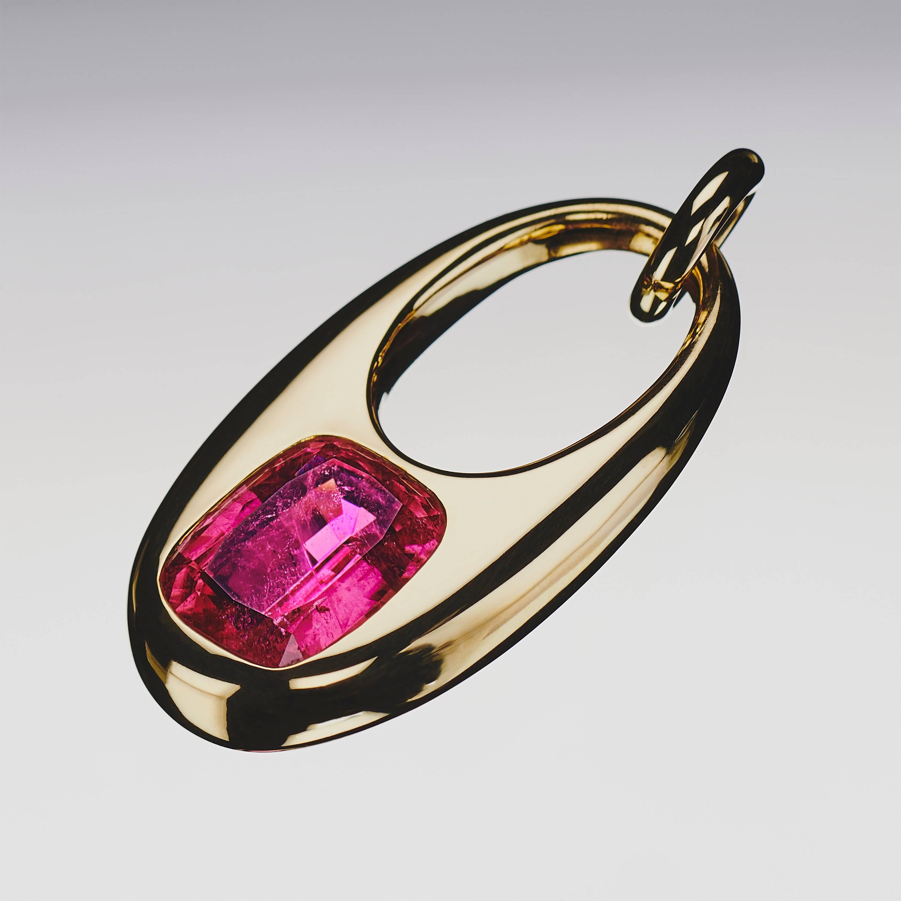Solid 18ct. gold pendant set with a faceted Brazilian Rubellite, cushion-shape 7.65 cts.
Stamped 750/.
One of a kind, unique piece jewelry, handmade in our workshop.
