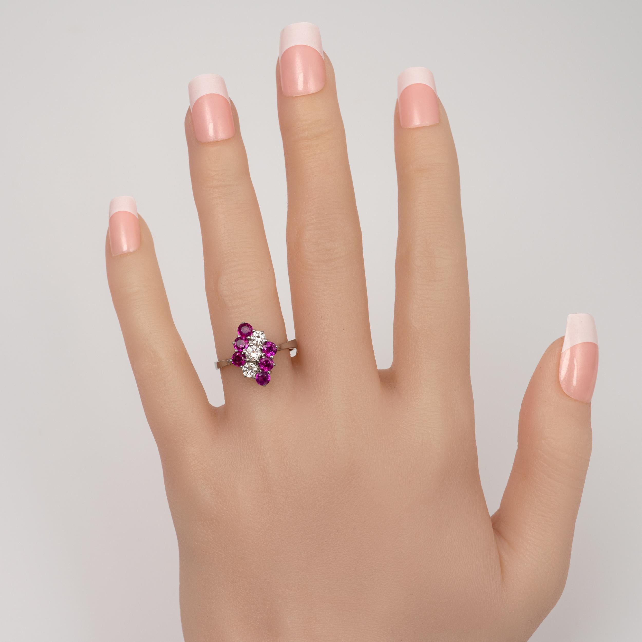 This pink tourmaline and diamond ring is beautifully crafted in 18k white gold and features 1.3 carats of sparkling gemstones neatly arranged into a diamond shape cluster.

The setting features a row of three round cut diamonds totaling approx 0.45