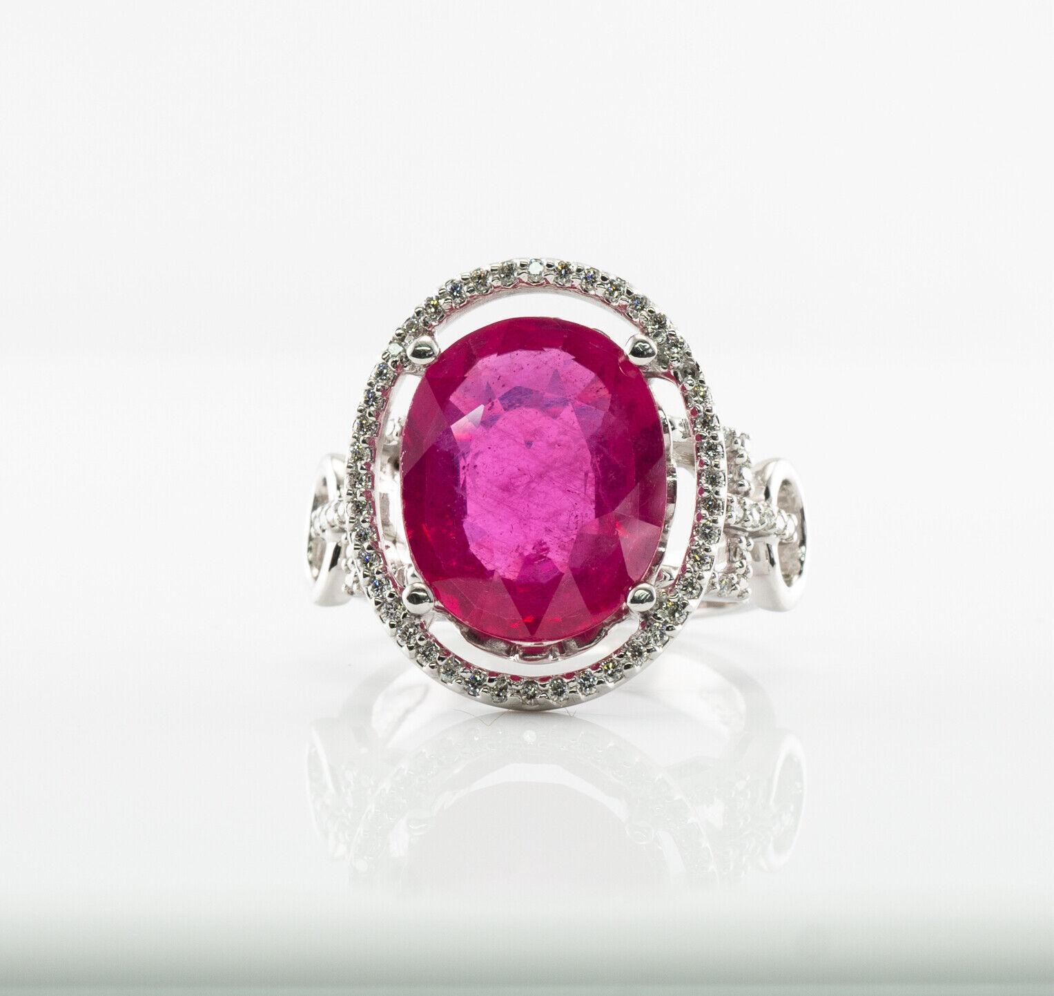 This gorgeous estate ring is finely crafted in solid 14K White gold and set with natural Earth mined Pink Ruby and diamonds. The center oval cut gem measures 14mm x 11mm (6.16 carats). This is a very good quality stone with great intensity and