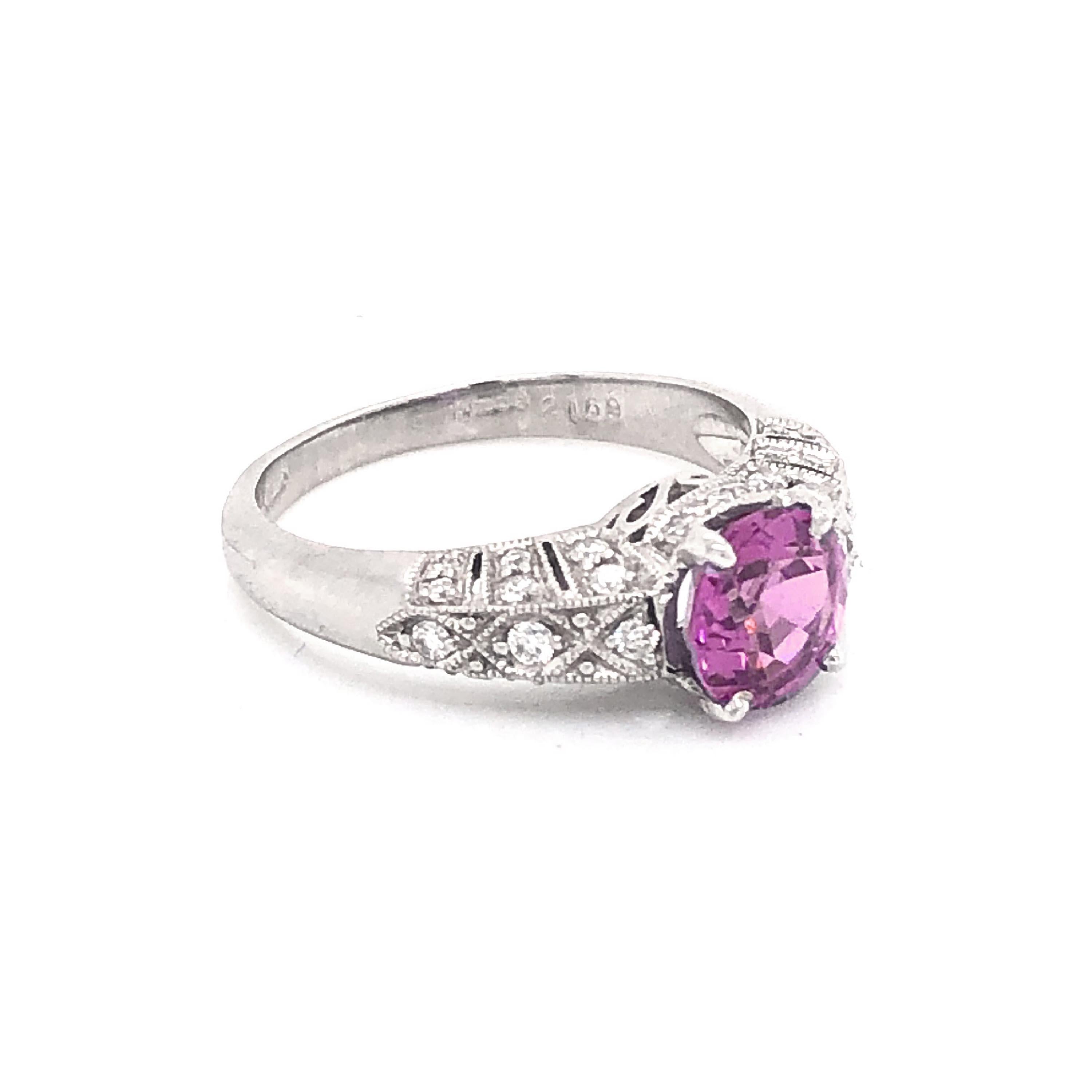 A pink sapphire ring, set with a pink sapphire, weighing approximately 1.57ct, with 0.31ct of round brilliant-cut diamonds set in the decorative, pierced shoulders, head and bezel, with millegrain edges, mounted in platinum.

Finger size M¼ / USA 6