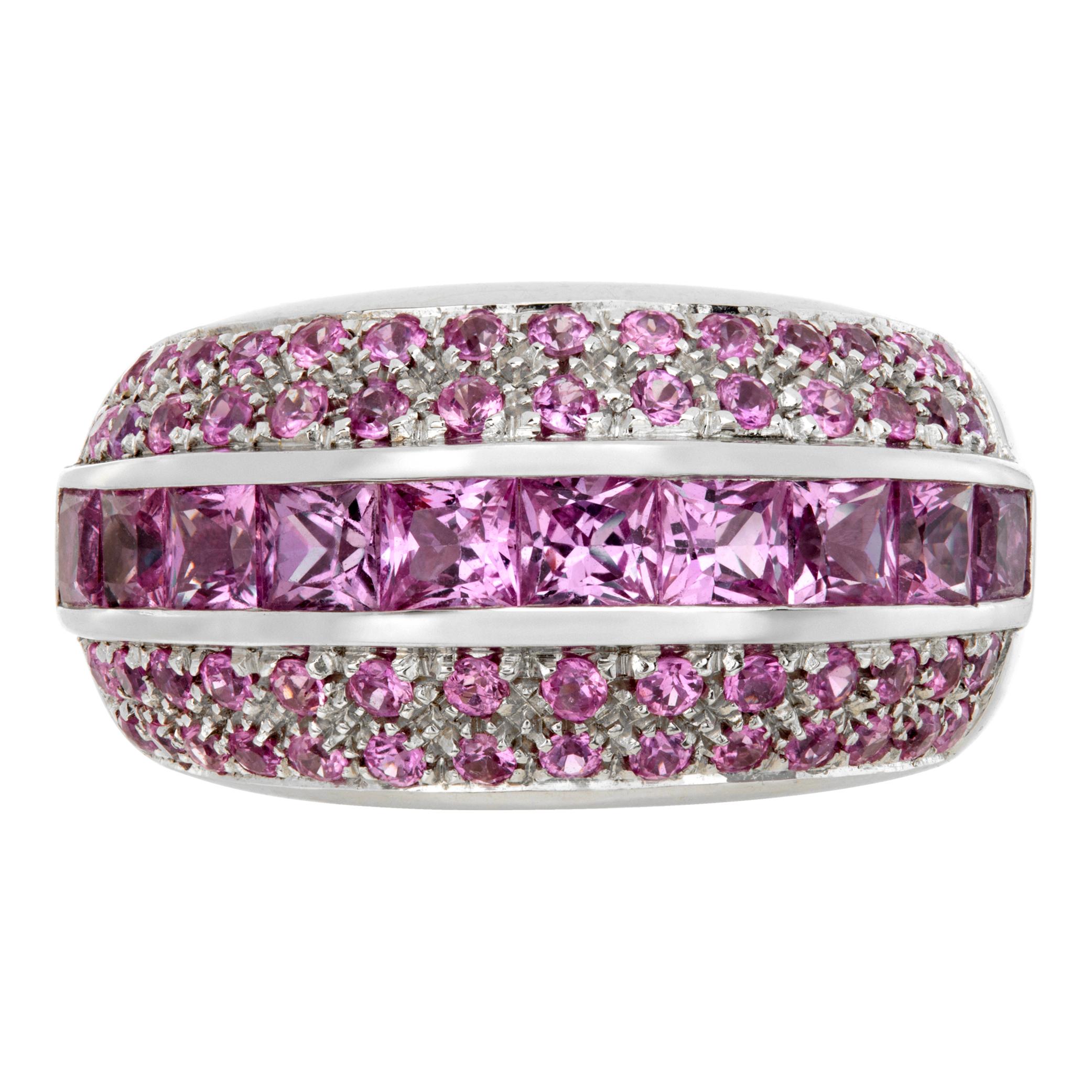 Pink sapphire ring in 18k white gold with approximately 3 carats in center channel set princess cuts and 4 rows of round prink sapphires. Ring size. 5.75

This Pink sapphire ring is currently size 5.75 and some items can be sized up or down, please
