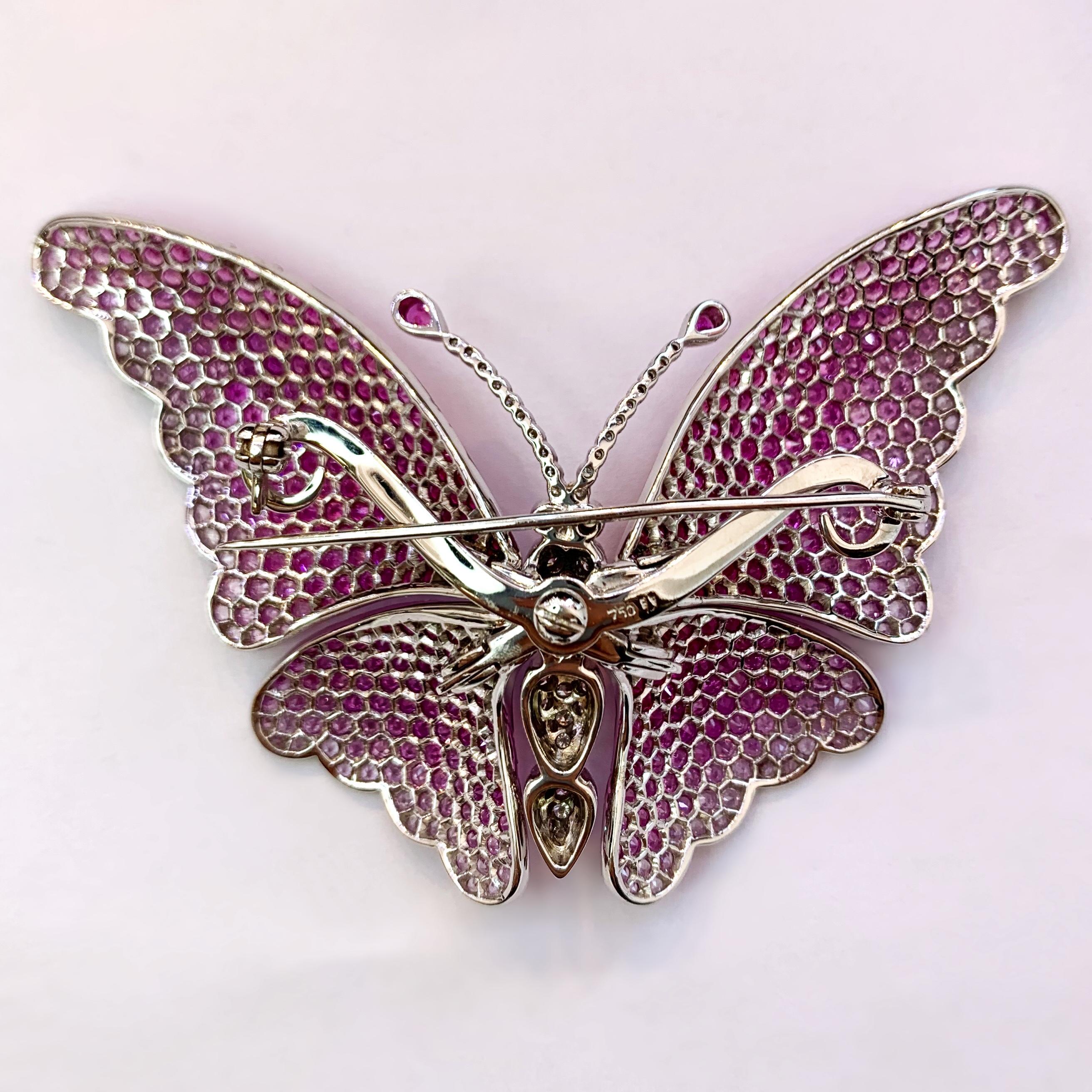 Butterflies aren't free but this is fabulous! This 18K white gold beauty is set with 554 round sapphires that have a color range of faint pink to hot pink with a total weight of approximately 13.85cts. The antennae are 2 pink pear shaped sapphires