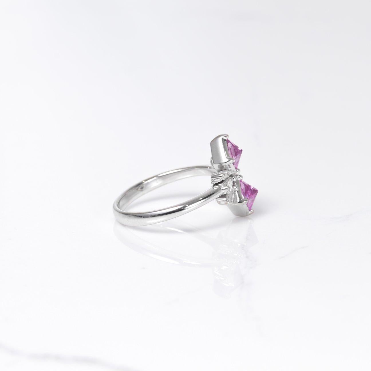 A stunning one of a kind ring! With princess cut pink sapphires set upside down creating such a unique look! These sapphire are a total of 1.03 carats. Accenting these beautiful sapphires are gorgeous diamond baguettes that total .36 carats. All set