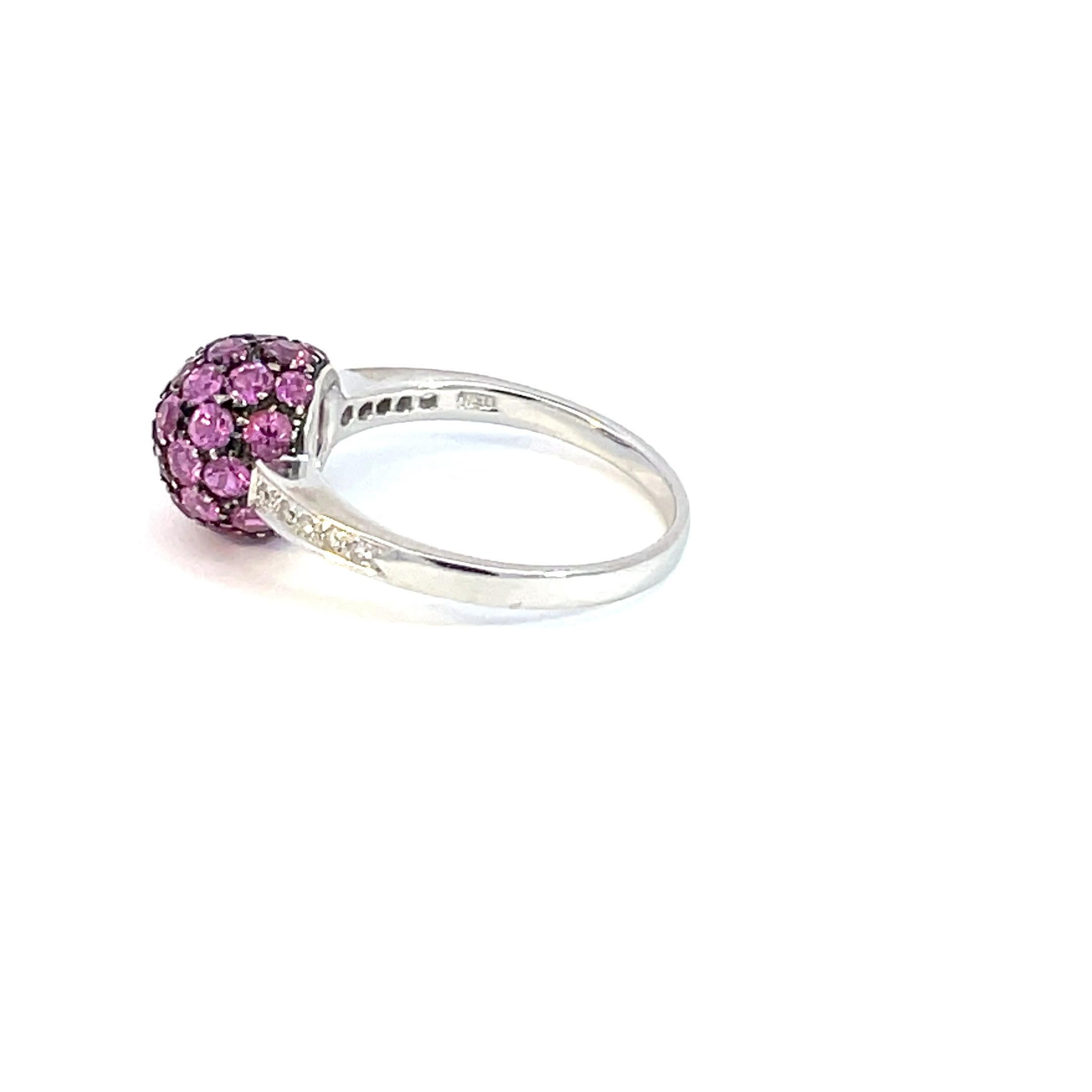 One 18kt white gold, natural pink sapphires and diamond ball ring with a black rhodium finish around the pink sapphires.

35 natural pink sapphires 1.05ct total weight 

10 brilliant cut diamonds 0.20ct total weight

18kt white gold 4.2 grams total